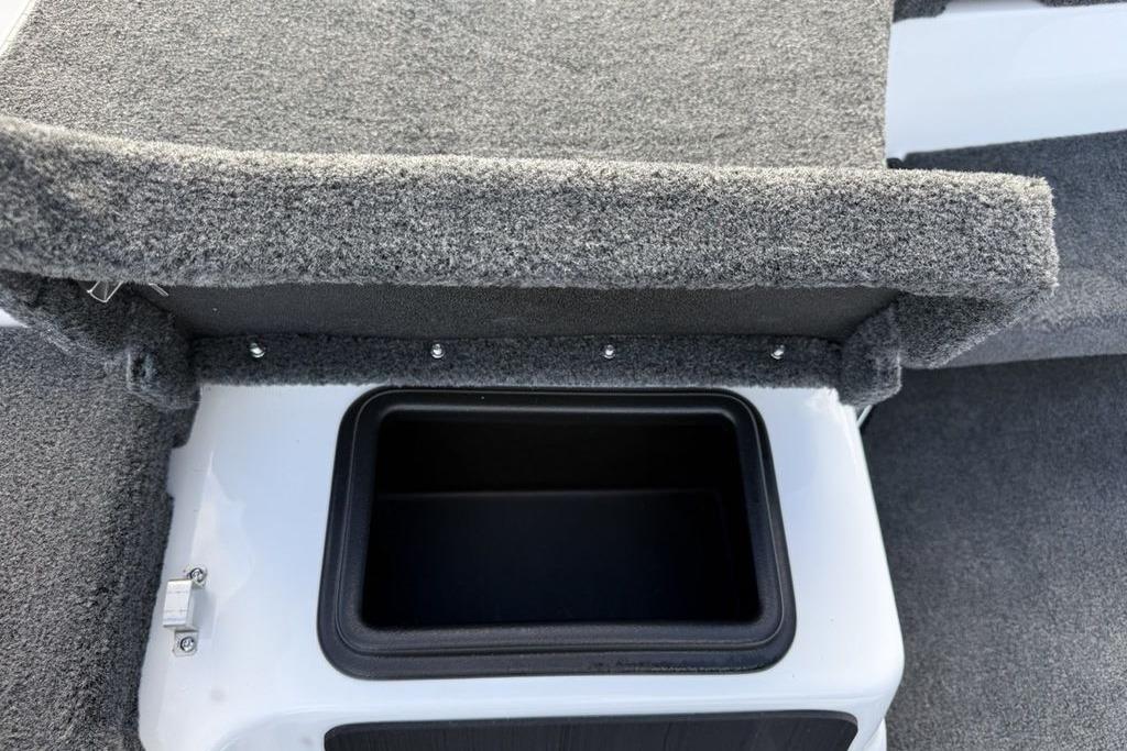 Carpeted storage compartment in 2026 Skeeter ZXR19 SE boat interior.