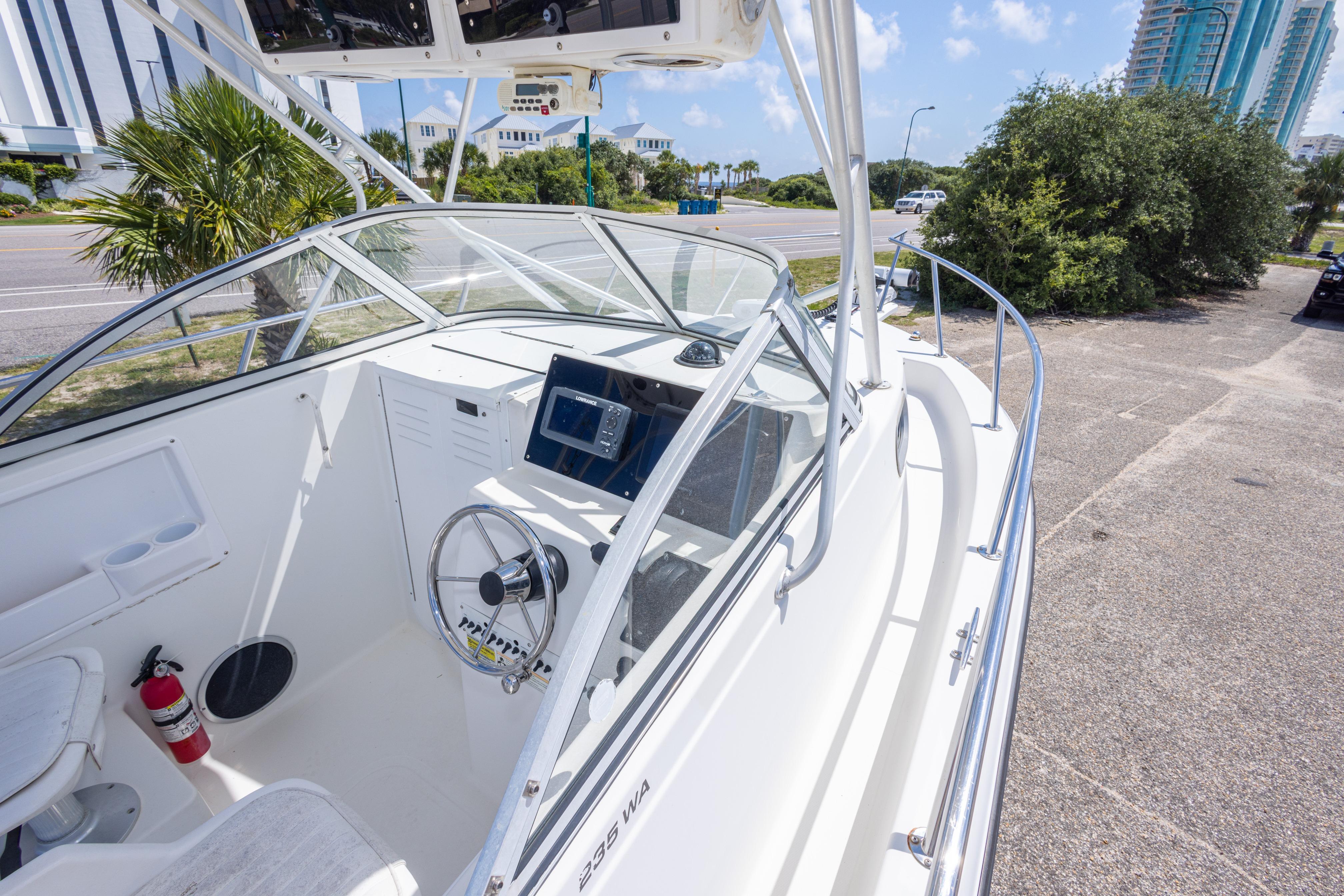 2007 Sea Boss 235 Walkaround boat interior with steering wheel and navigation equipment.