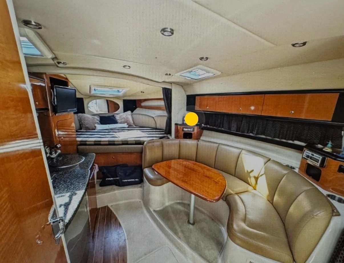 Interior of a 2006 Chaparral Signature 310 yacht with seating area and bed.