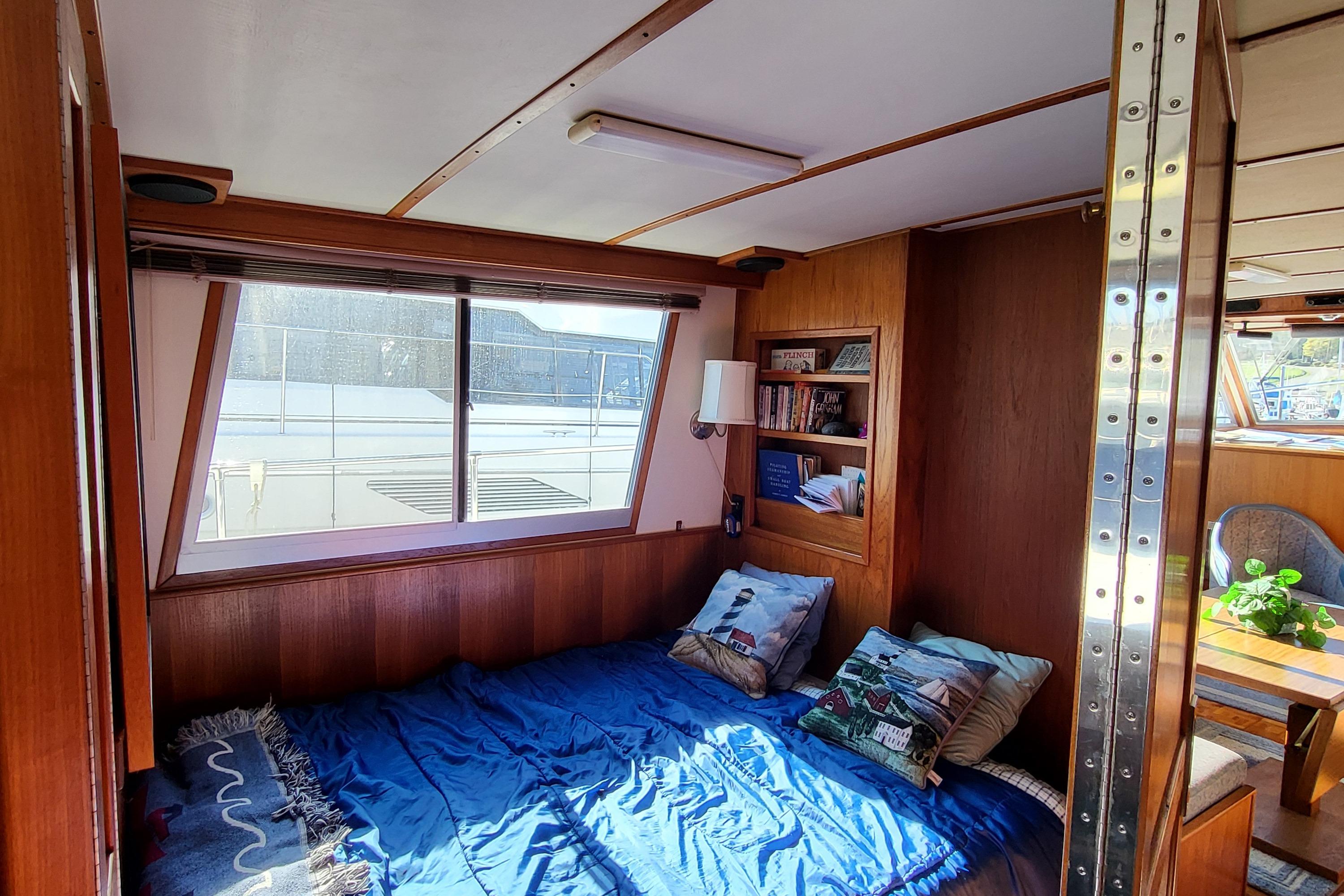 Cozy cabin interior of 1992 Corsair 42 boat with bed and window view.