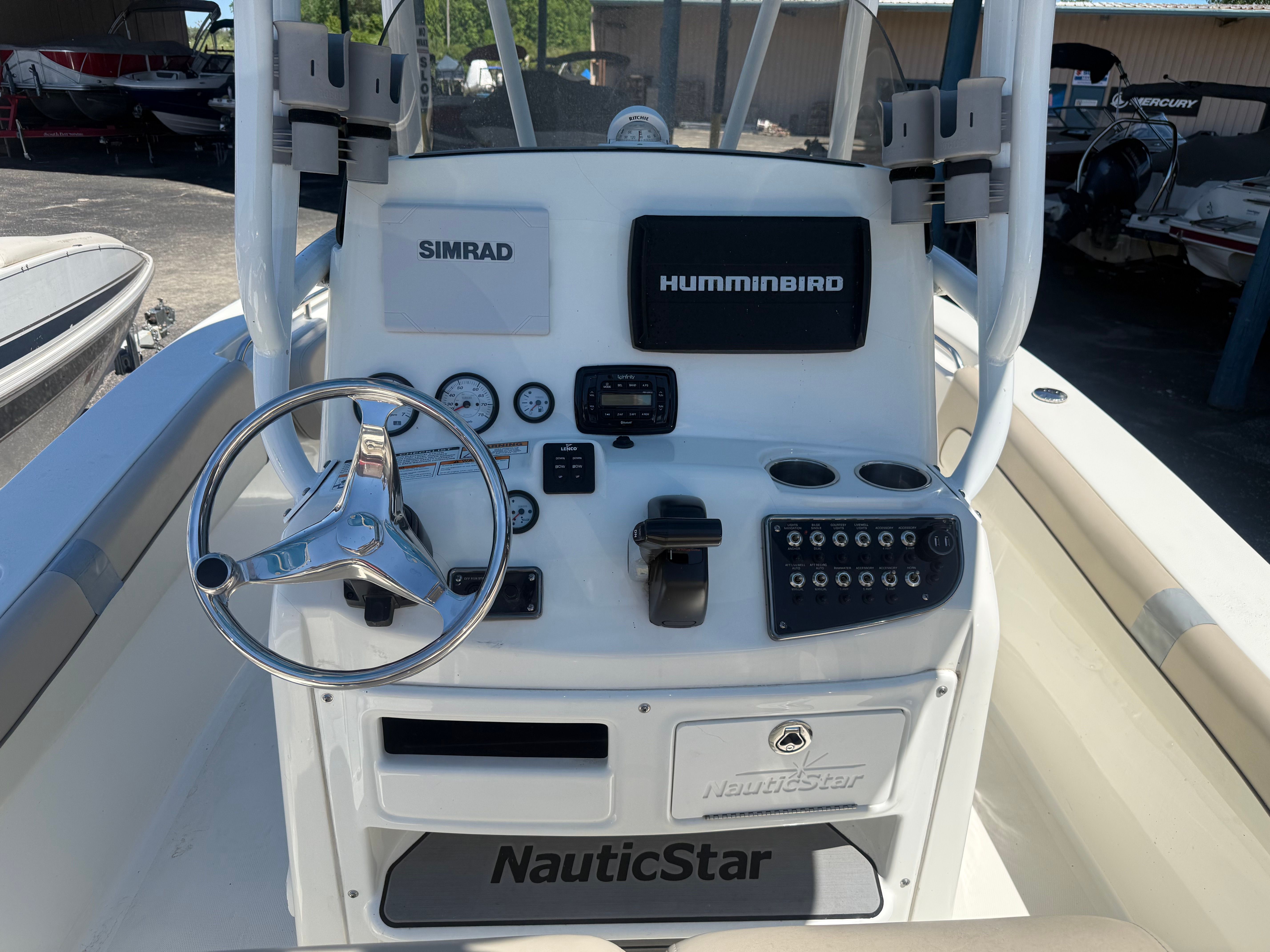 The cockpit of a NauticStar 22 XS boat with steering and instruments.