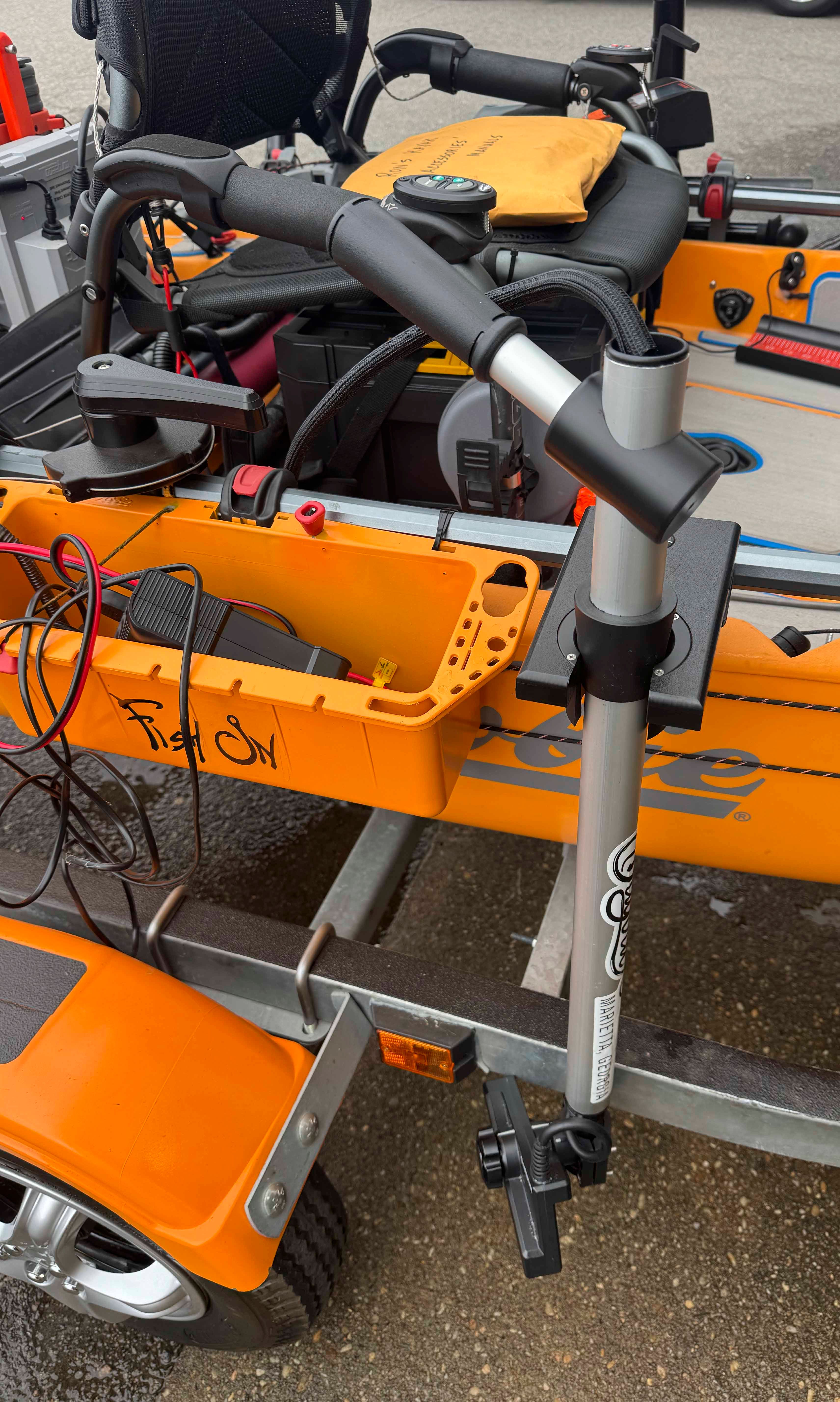 Close-up of an orange Hobie 14 Pro Angler Kayak on a trailer.