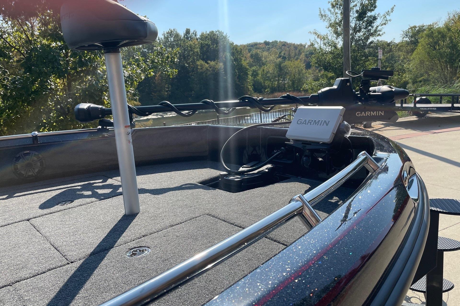 2026 Nitro ZV19 Sport Pro boat with Garmin equipment, docked near a scenic river.