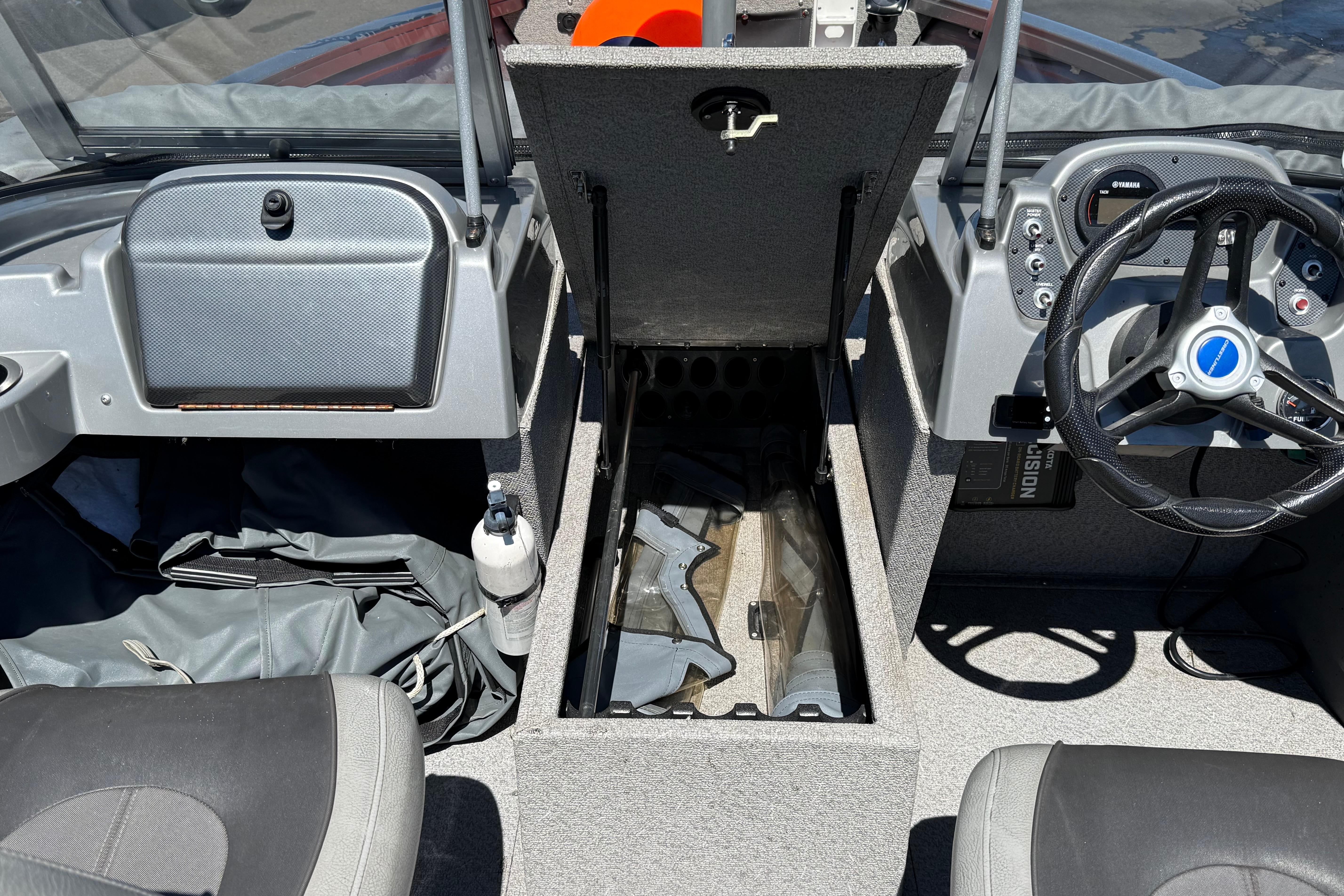 2016 Crestliner 1700 Vision boat interior with open storage compartment and steering wheel.