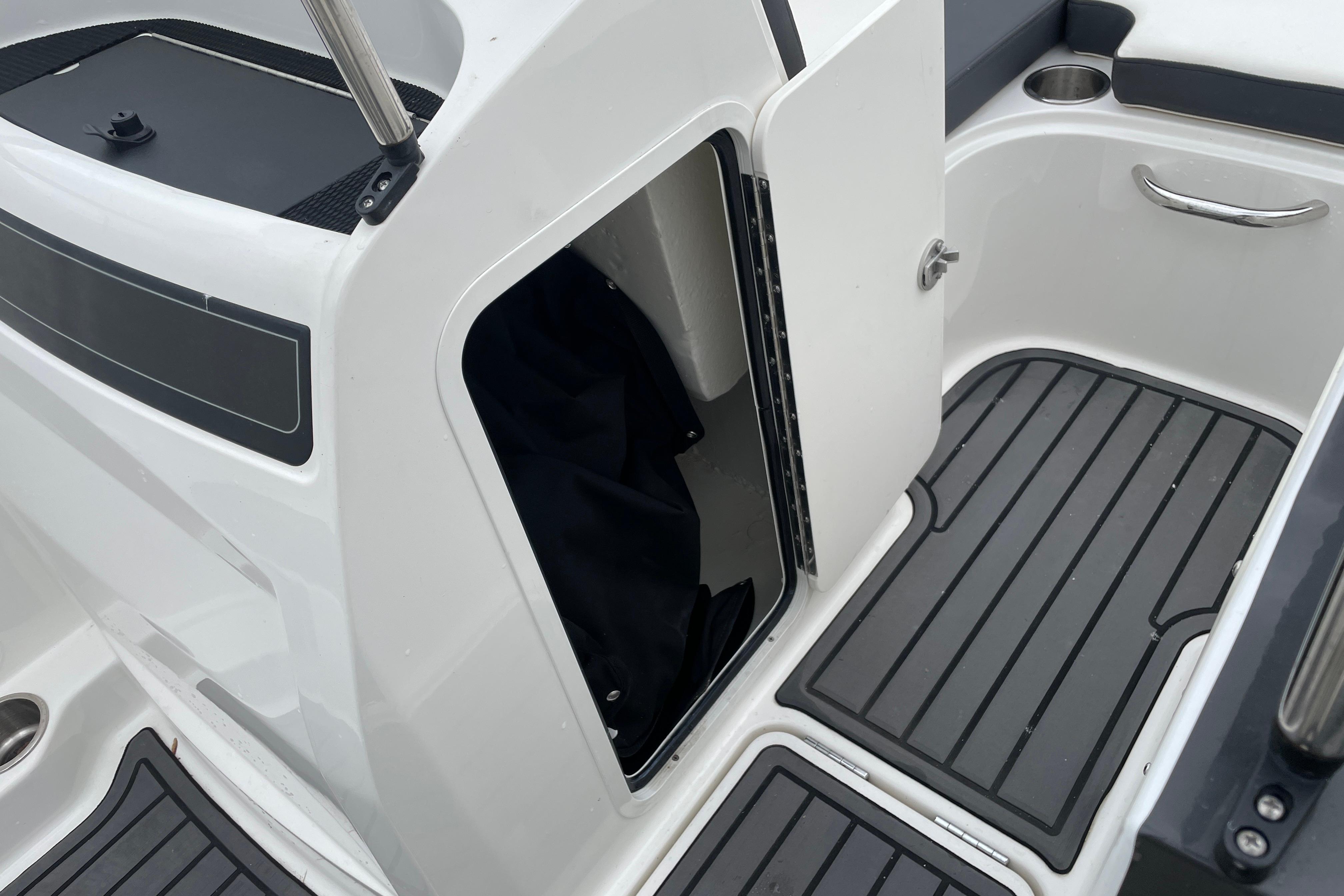 2023 Bayliner VR4 Bowrider OB interior with open storage compartment and sleek flooring.