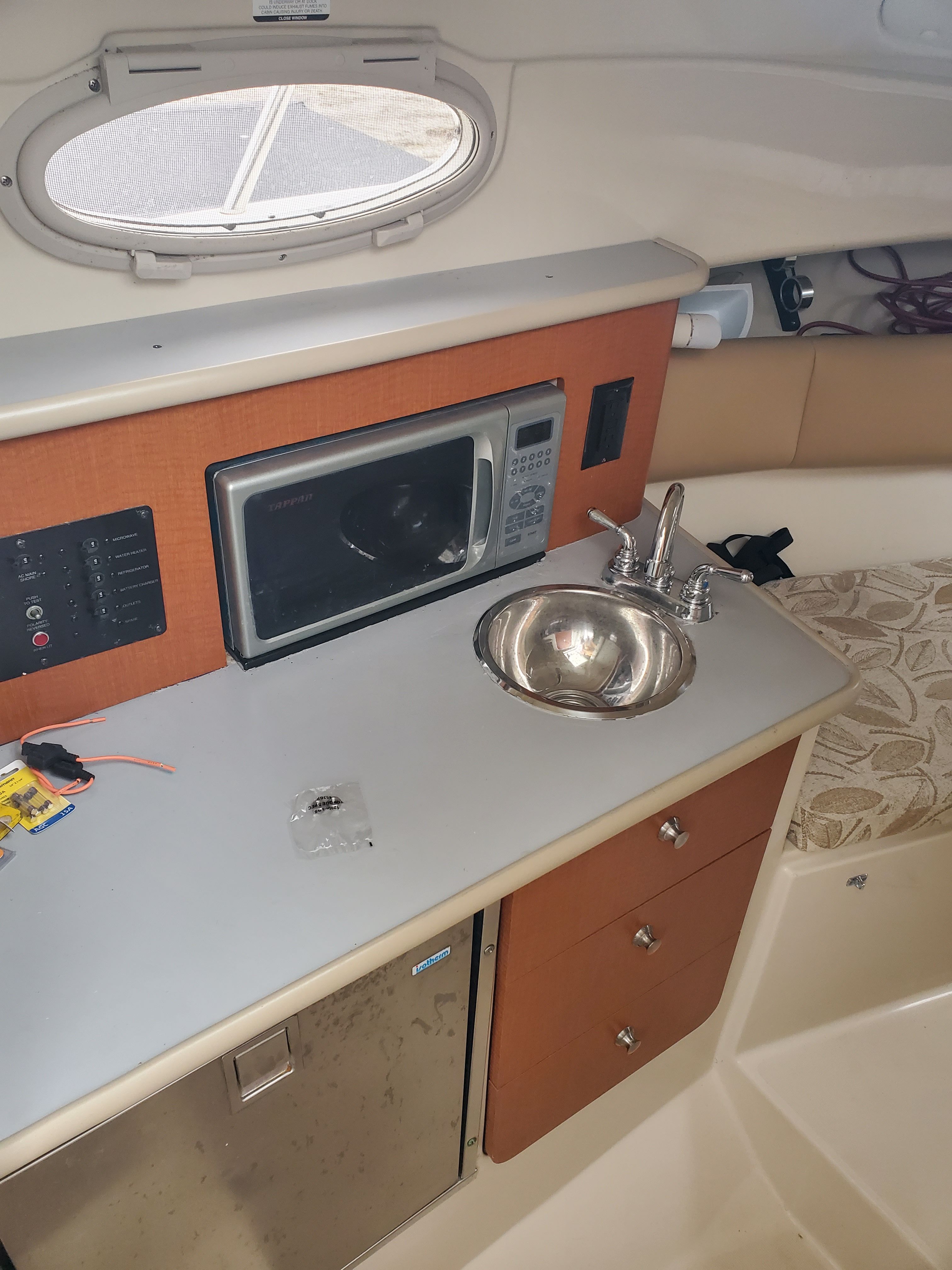Interior of 2005 Robalo R265 Walkaround with kitchenette and sink.
