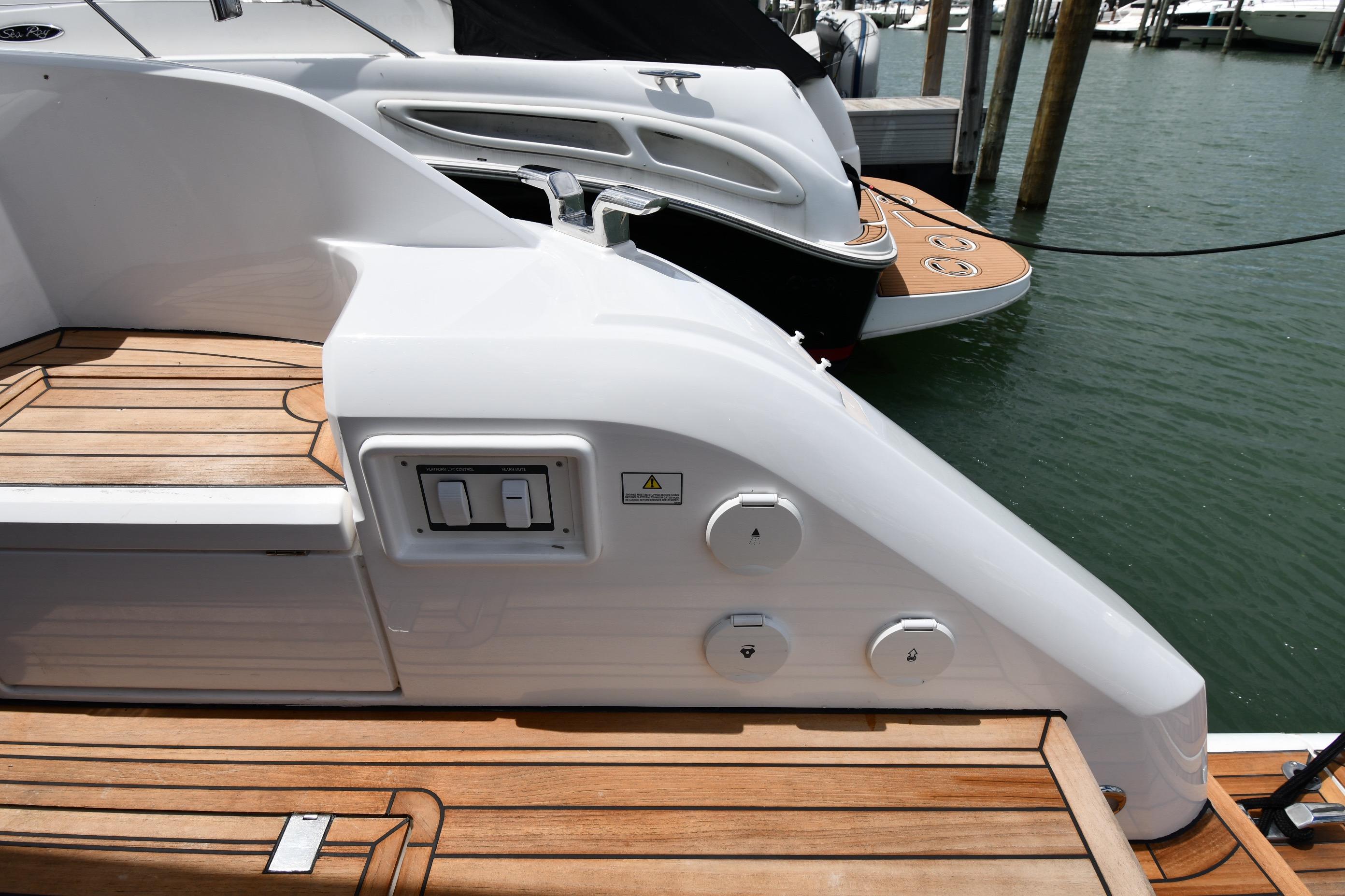 2024 Fairline G50 Targa yacht with sleek design and wooden deck at marina.