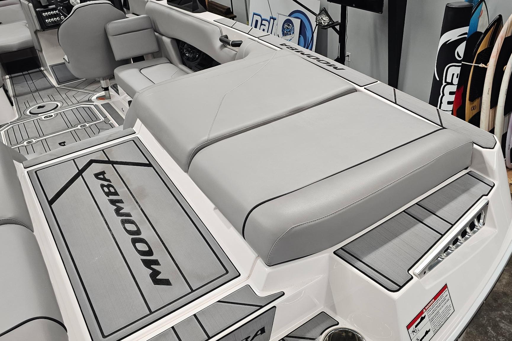 2024 Moomba Mojo boat interior with gray seating and branded flooring.