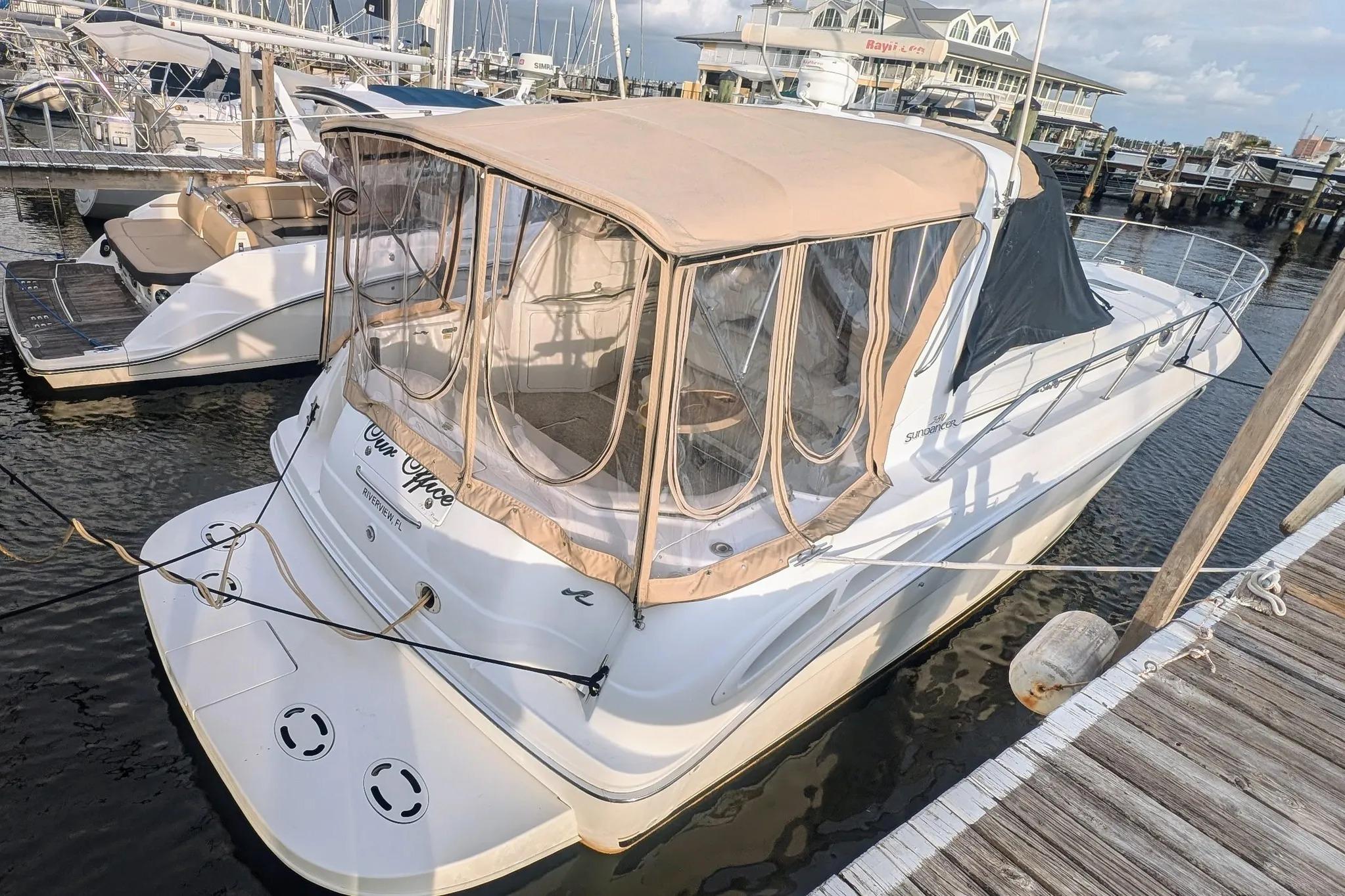 2000 Sea Ray 380 Sundancer docked at marina with beige canopy.