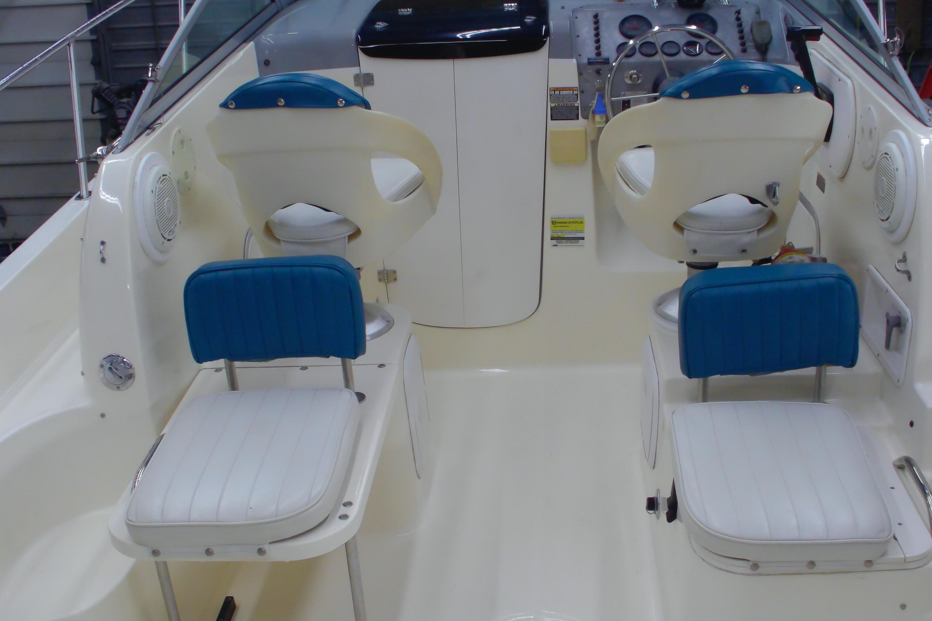 2004 Trophy 2352 Walkaround boat interior with blue and white seating and control panel.