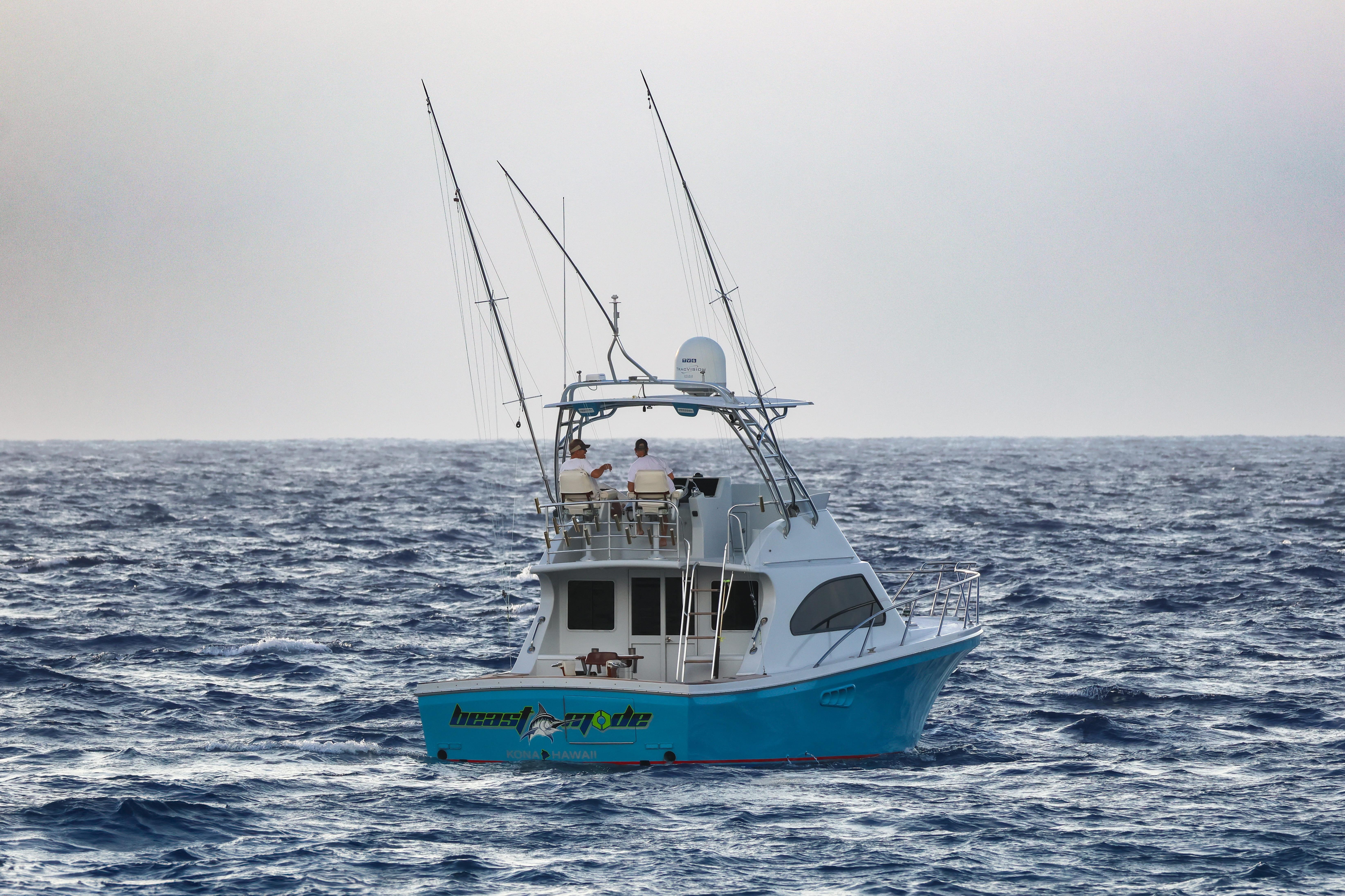 2001 Black Watch 40 boat on open ocean with fishing rods.