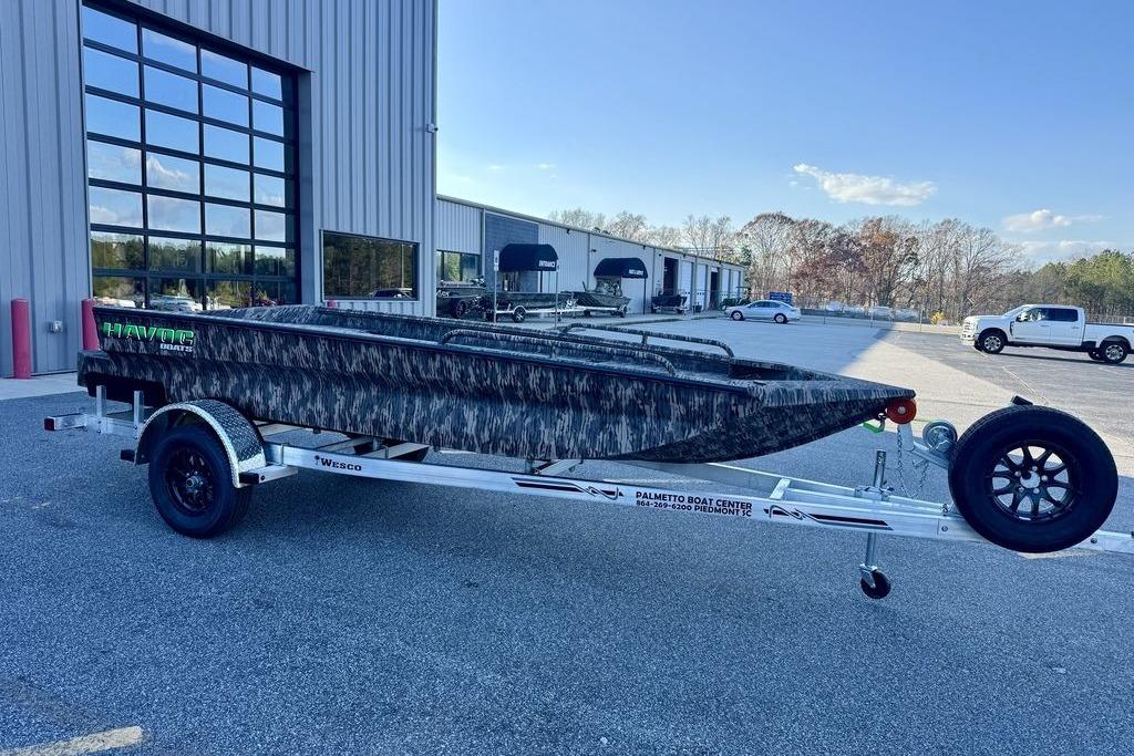 2026 Havoc 1756 boat on trailer, parked outside a modern building.