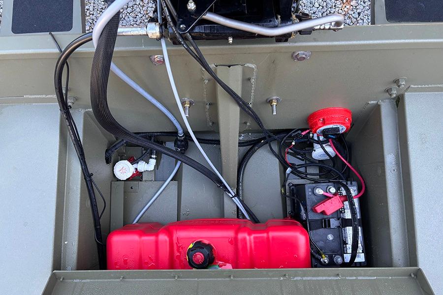 2022 Lowe Roughneck 1660 boat interior showing battery, wiring, and fuel tank setup.