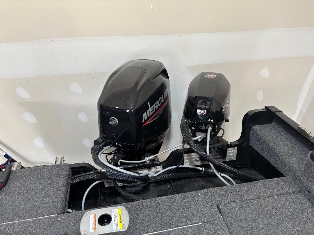 Two Mercury outboard motors are mounted on a boat.