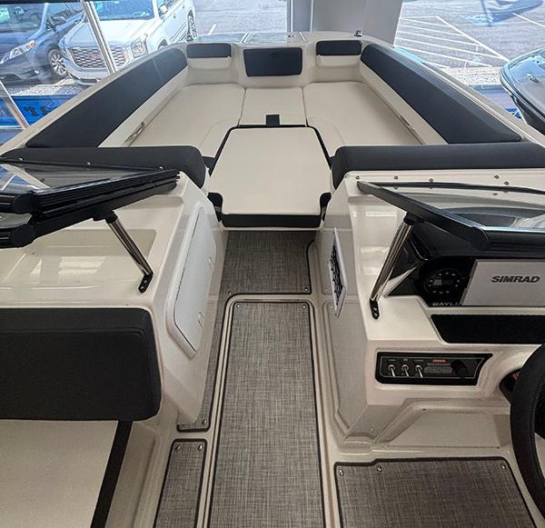 2024 Bayliner DX 2050 boat interior with seating and control panel.