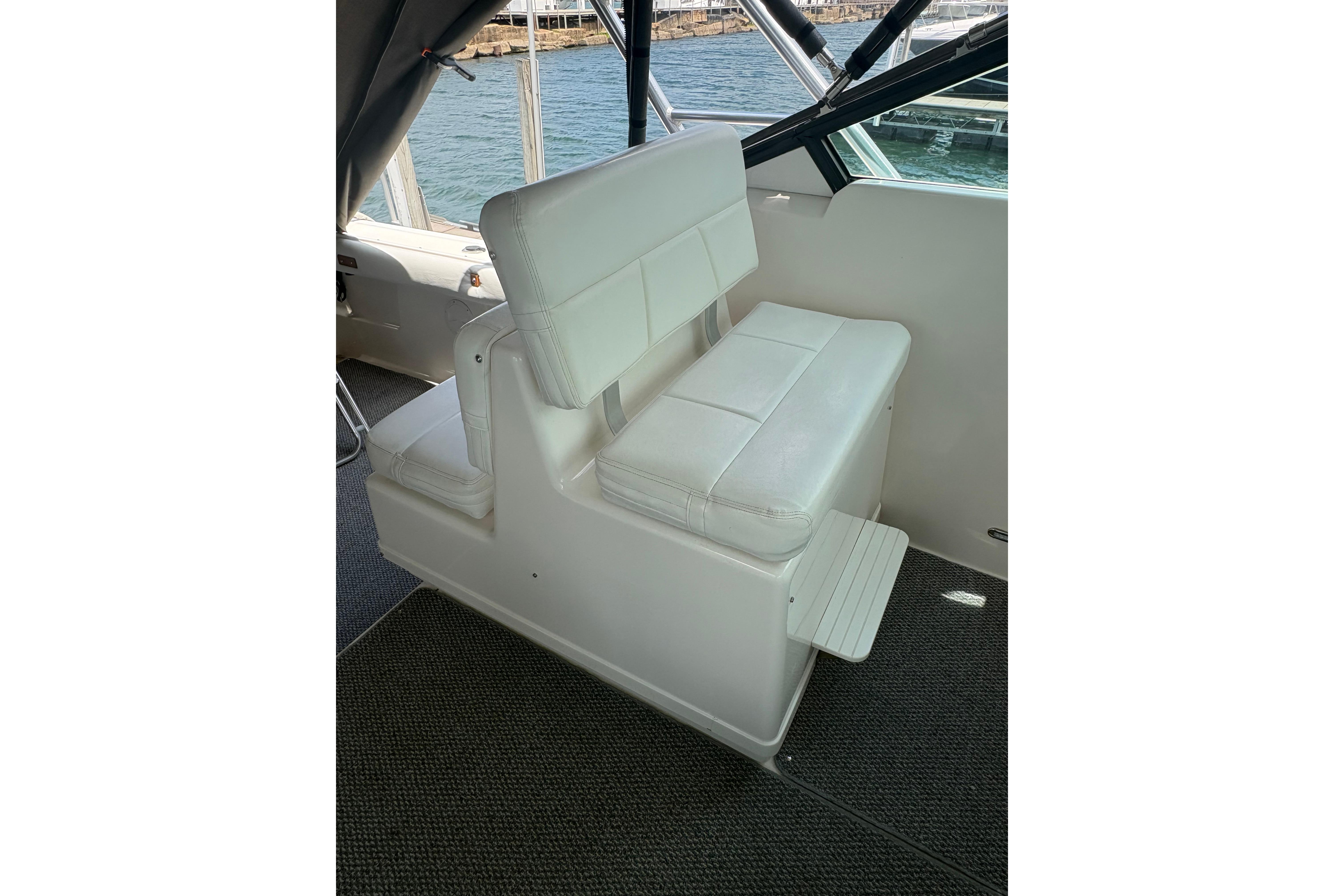 1999 Tiara Yachts 3100 Open interior seating with white upholstery and ocean view.