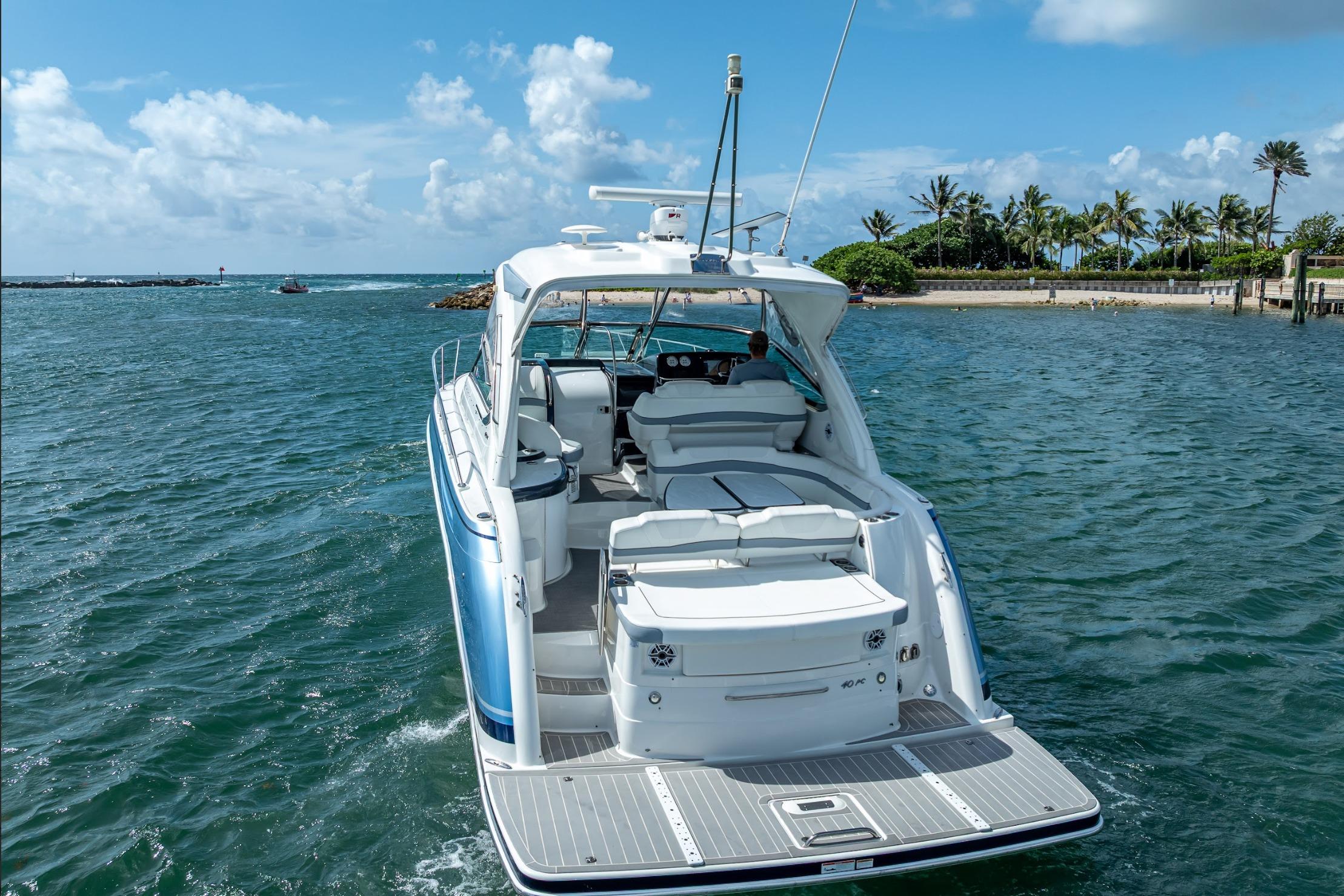 2022 Formula 40 Performance Cruiser on open water, clear sky, and tropical shoreline.