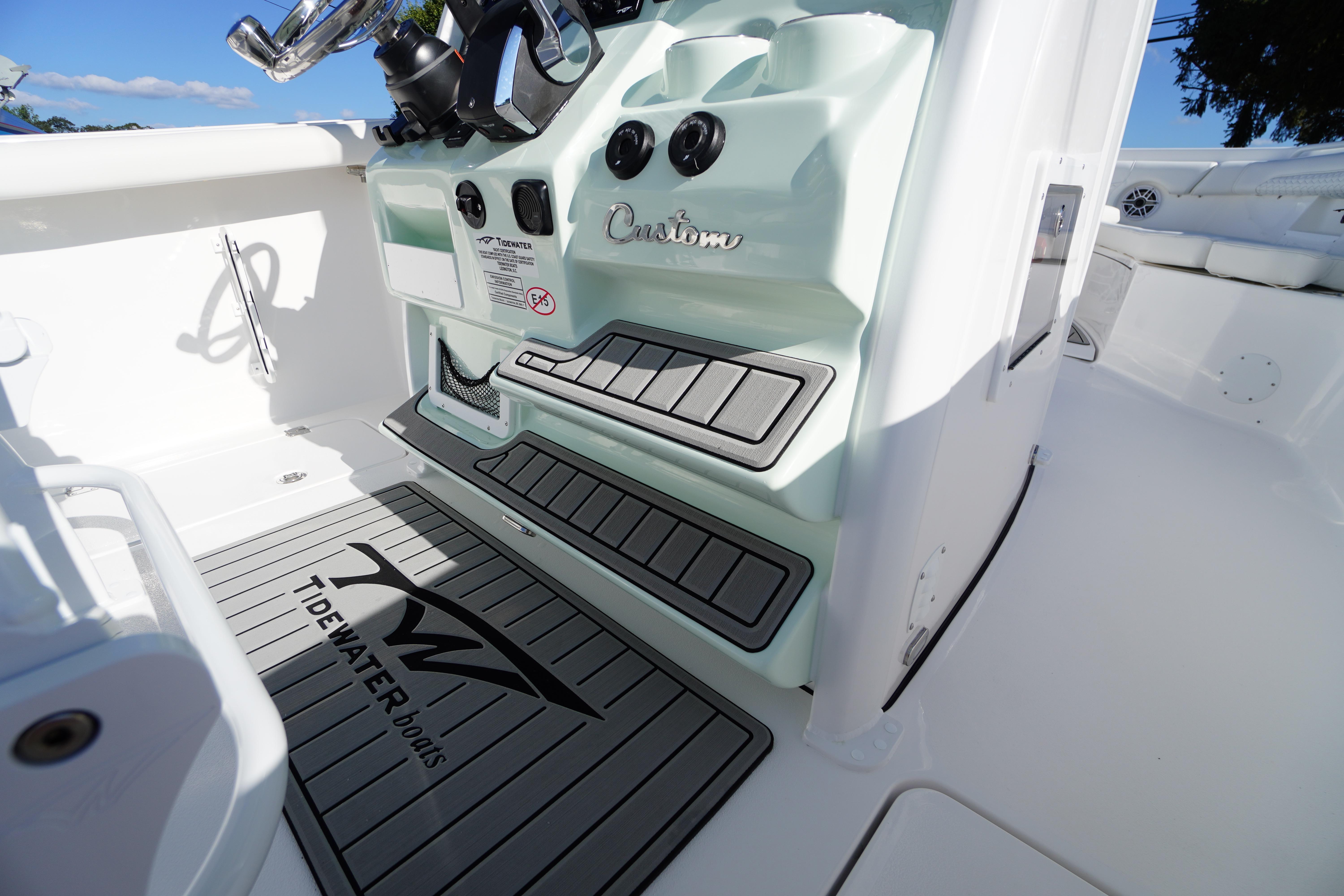 2026 Tidewater 272 LXF boat interior with custom console and branded flooring.