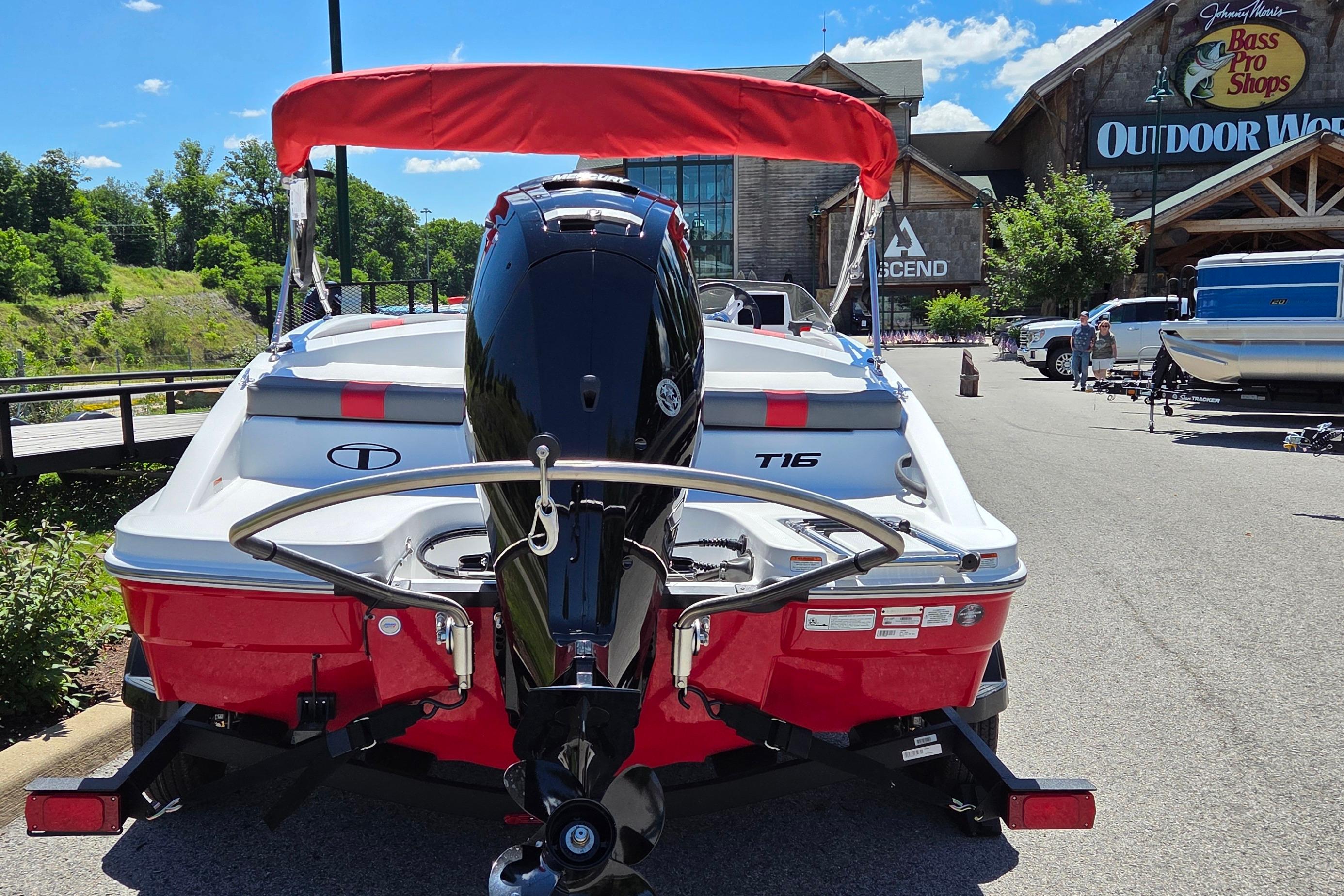 2026 Tahoe T16 boat with red canopy parked outside Bass Pro Shops.