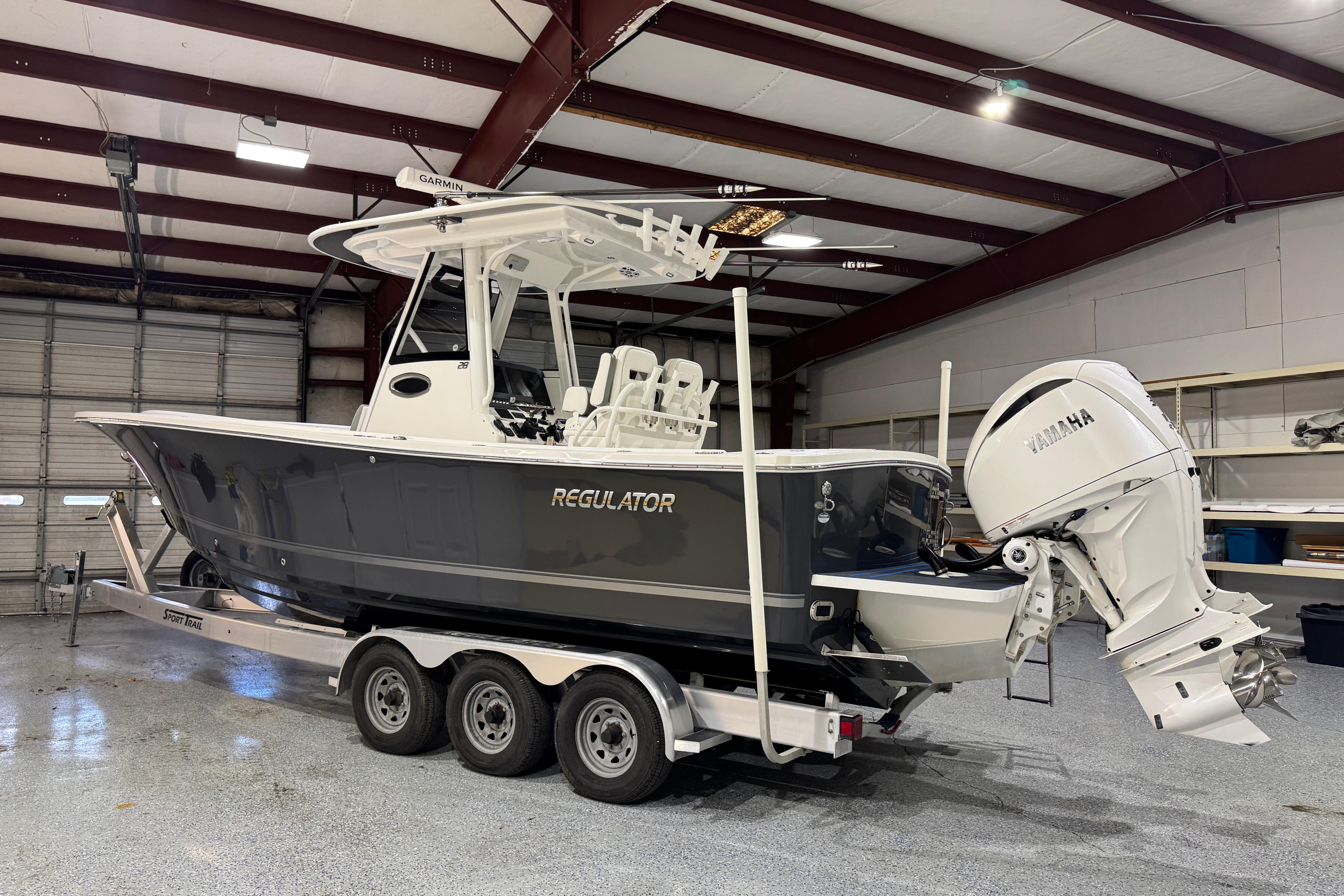 2023 Regulator 28 boat with Yamaha engine in a garage setting.