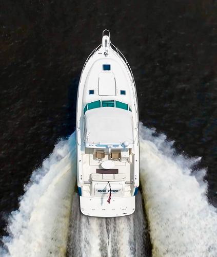 Aerial view of 1996 Tiara Yachts 3500 Express cruising on water.