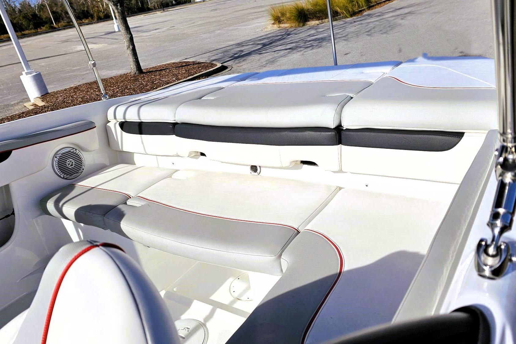 2023 Tahoe 210 Si boat interior with white and gray seating, red accents.