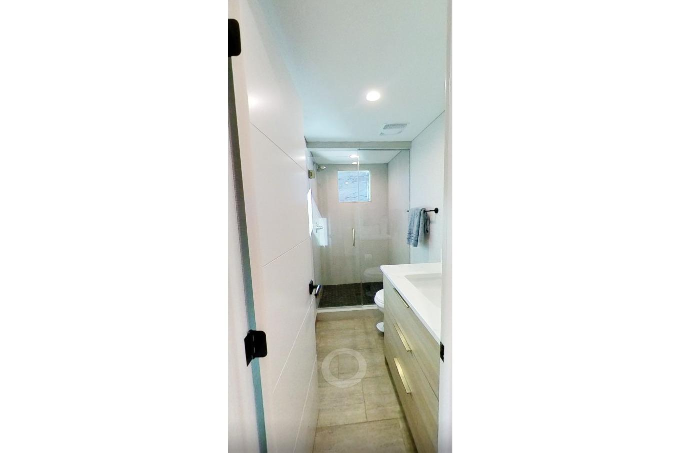 Modern bathroom in 2022 Adonia Splendor RV, featuring sleek design and spacious shower.