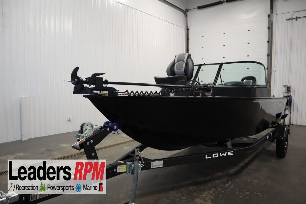 2026 Lowe Fishing Machine 175 boat on trailer in indoor showroom.