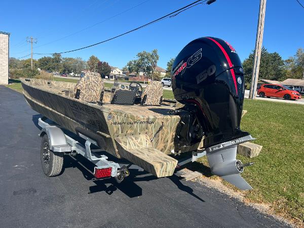 2025 Lowe Roughneck 2070 SC boat with camo design and powerful outboard motor.