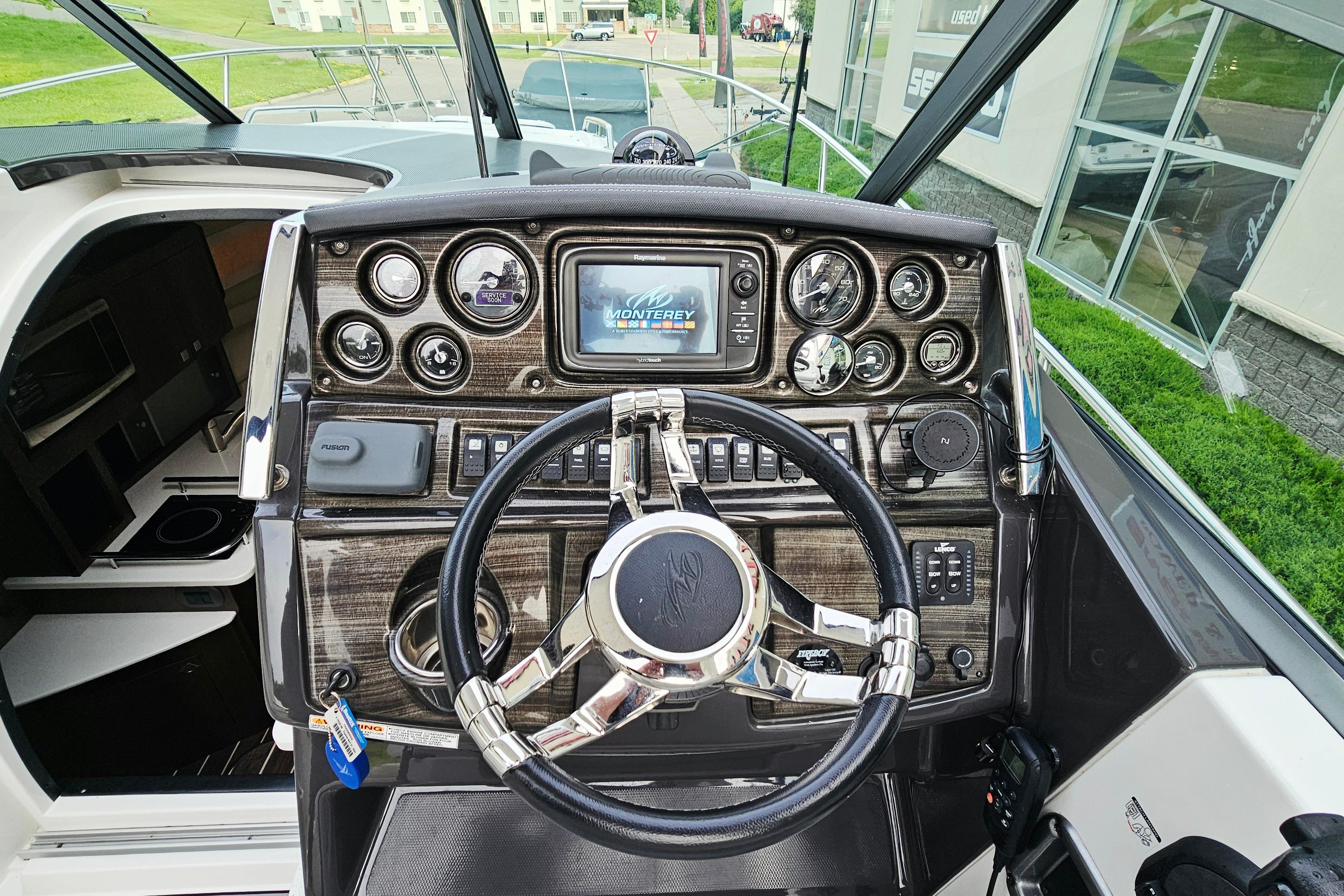 Helm of 2016 Monterey 295 Sport Yacht with modern controls and navigation system.