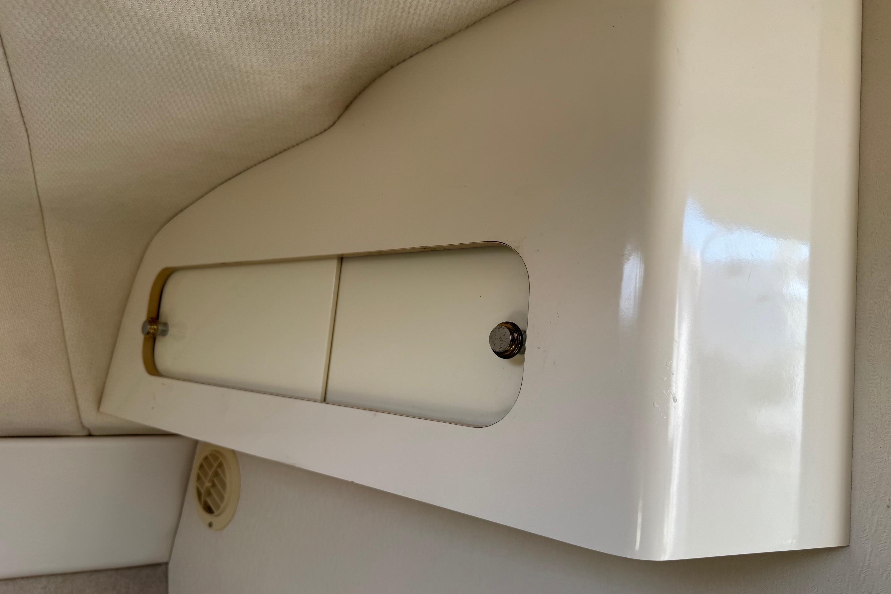 Interior cabin detail of a 2000 Maxum 2400 SCR boat, featuring a storage compartment.