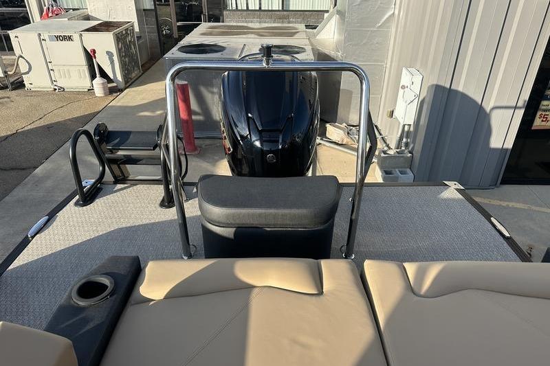 2026 Evotti 523CS boat interior with seating and motor, docked near industrial area.