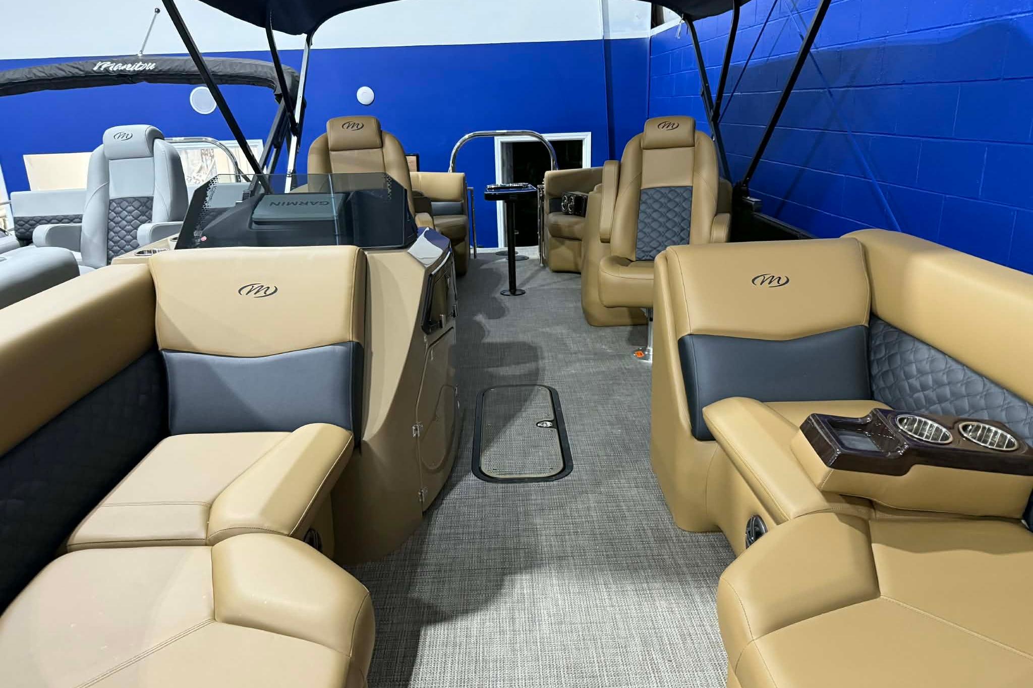 2026 Manitou Encore VP 230 pontoon boat interior with tan and gray seating.