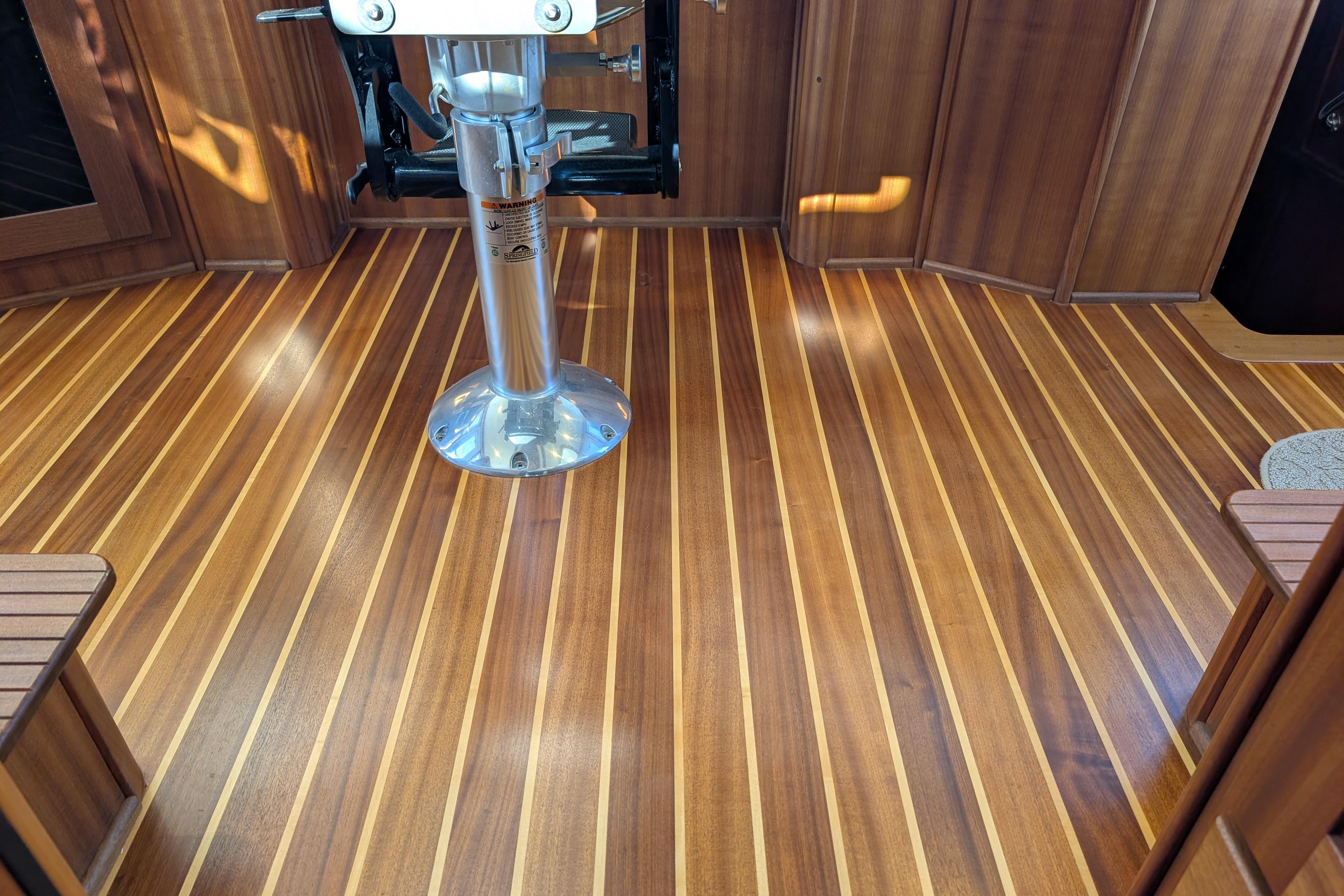 Polished wooden interior flooring of a 2015 American Tug 435 boat.