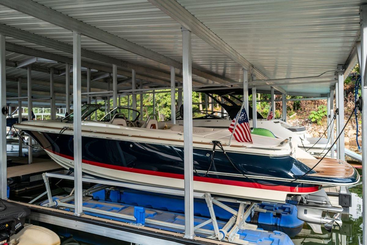 2023 Chris-Craft Launch 27 boat docked, featuring sleek design and American flag.