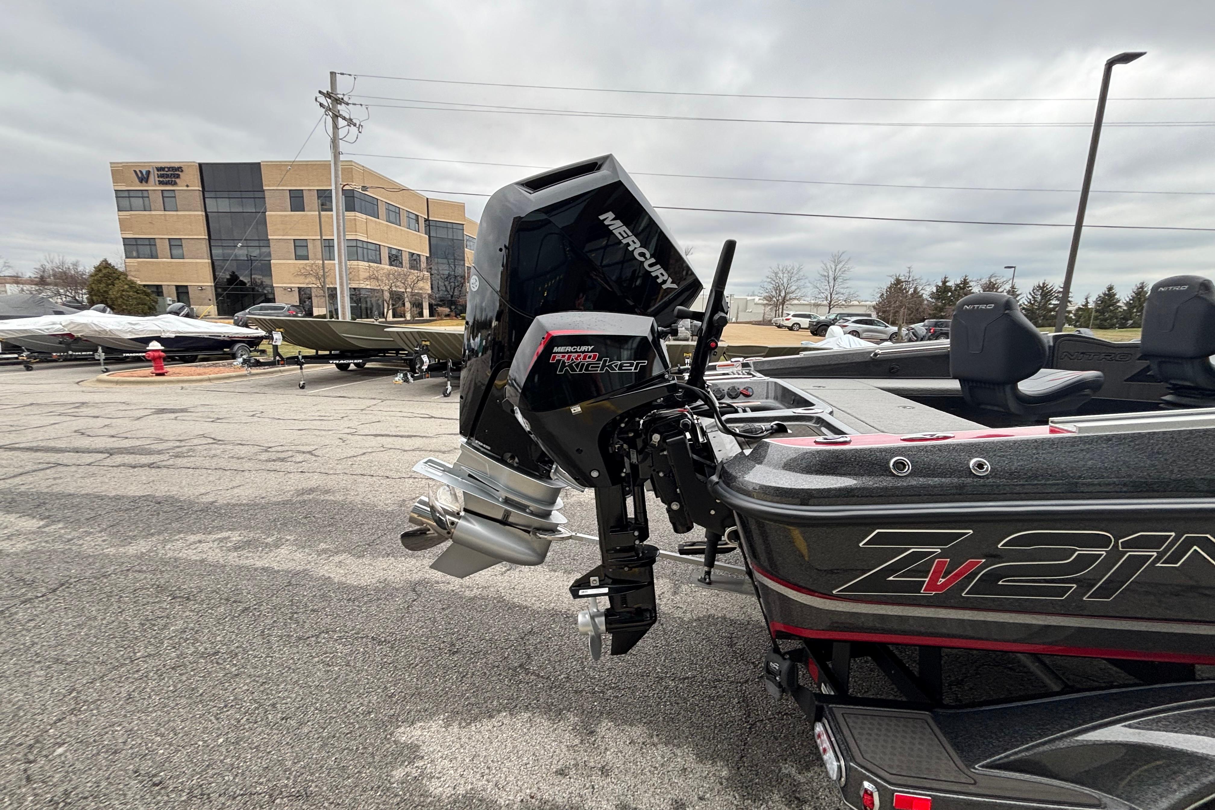 2024 Nitro ZV21 Pro boat with Mercury engine in parking lot.