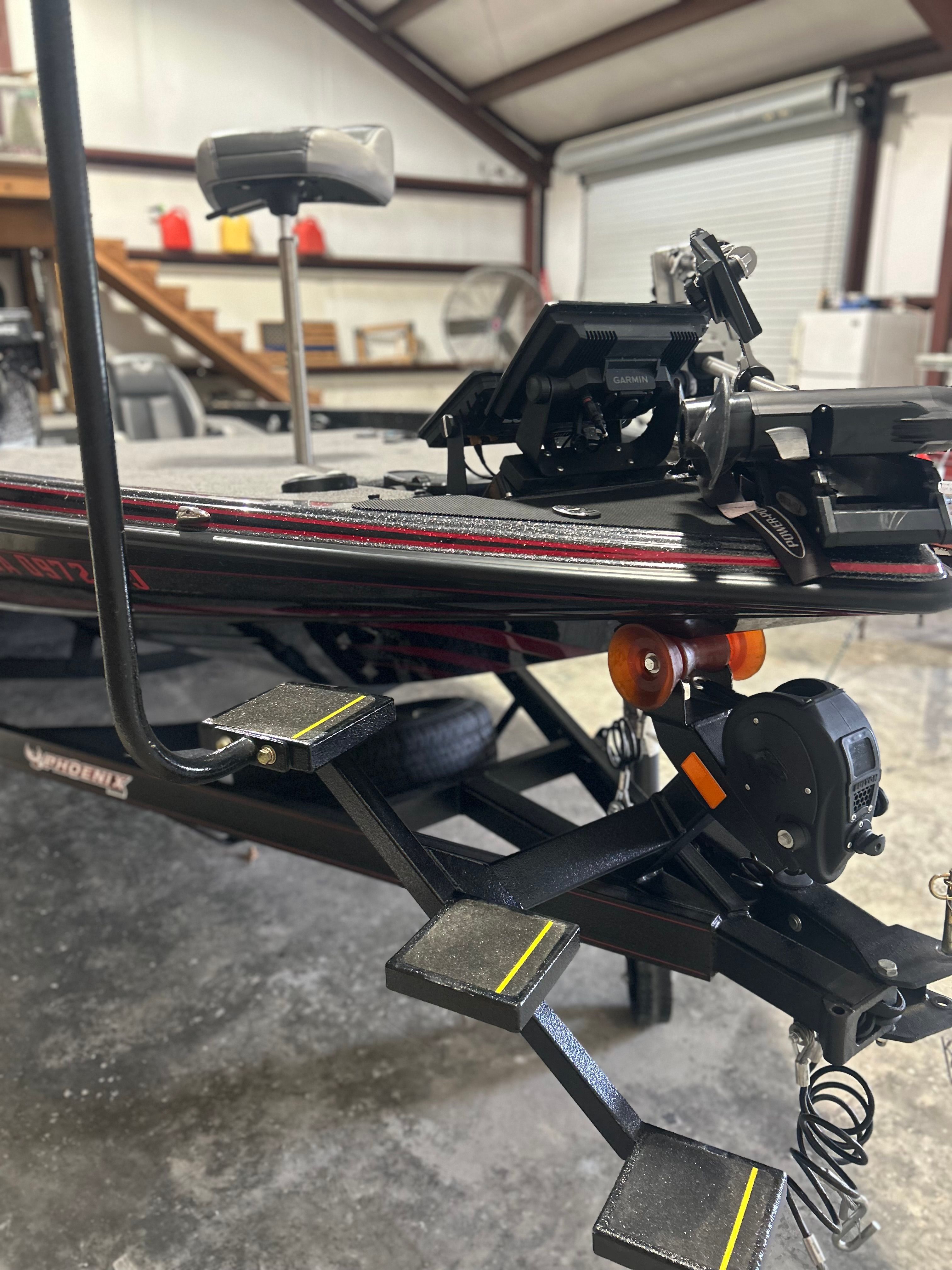 The 2025 Phoenix 921 Elite is on a trailer in a storage facility.