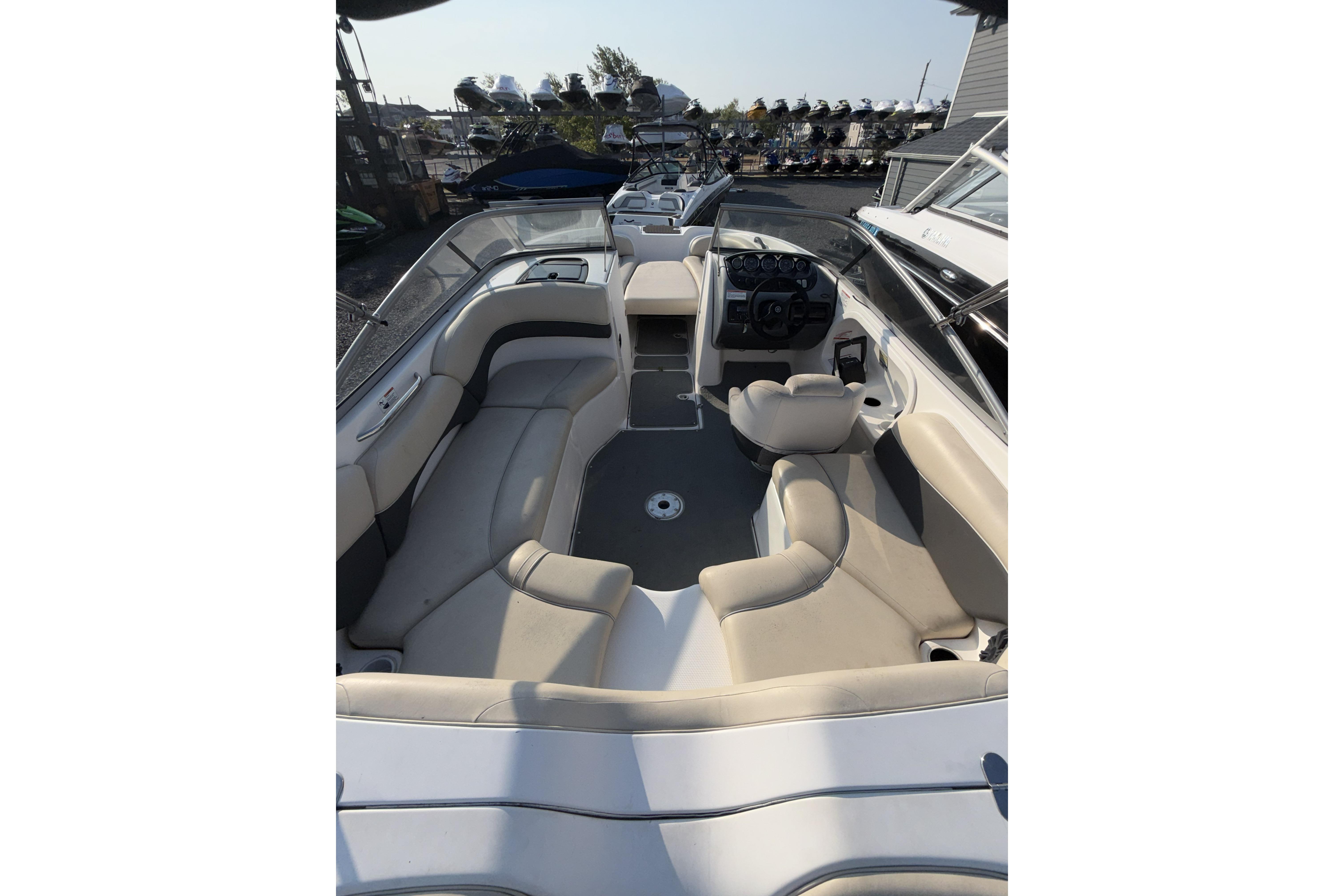 2006 Yamaha Boats SX210 interior with beige seating and steering console.