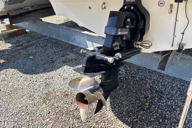 2012 Tahoe Q8 SSi boat with MerCruiser outdrive on a trailer, showcasing propeller detail.