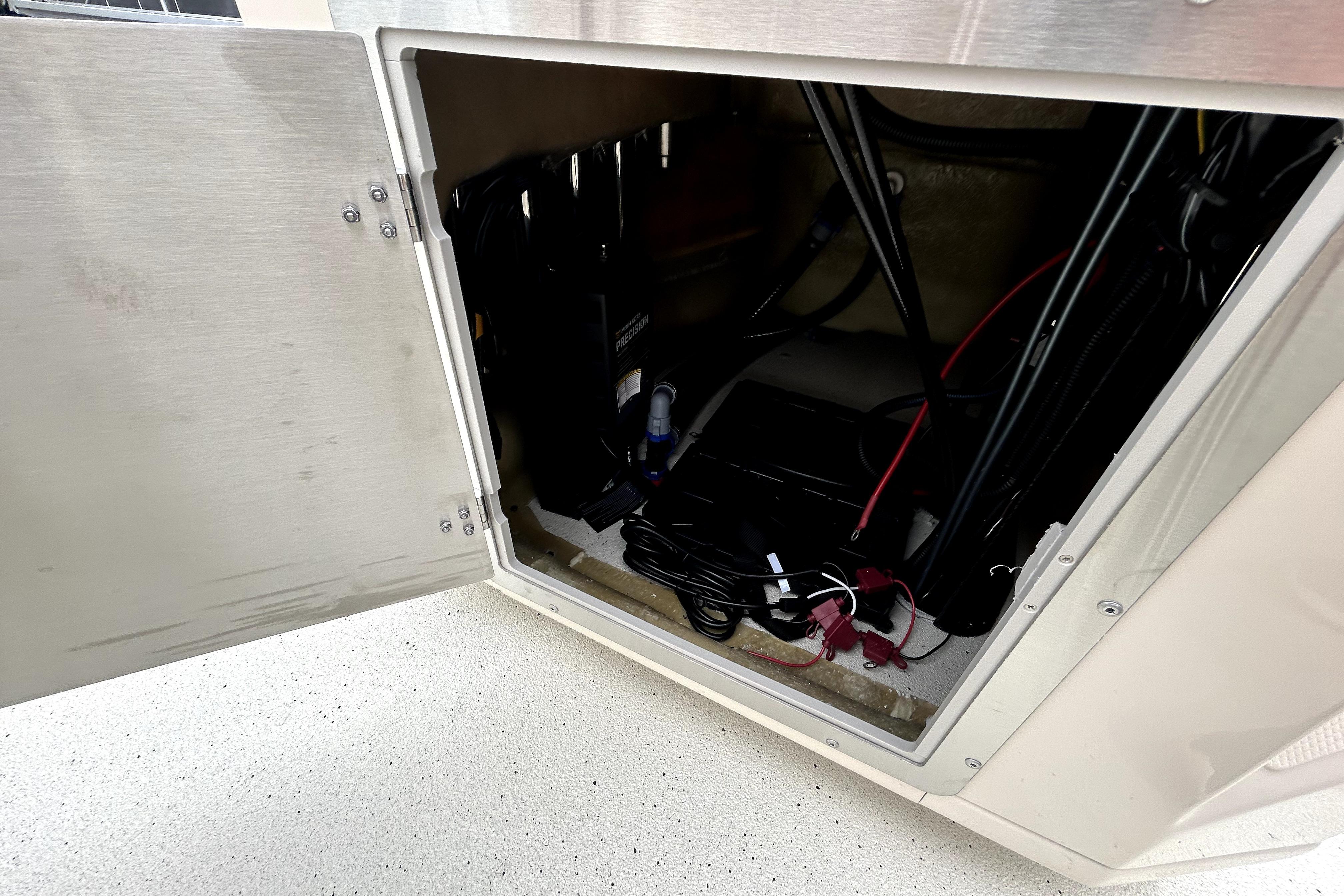 Open compartment of 2026 Xpress H20B Bay boat showing internal wiring and components.