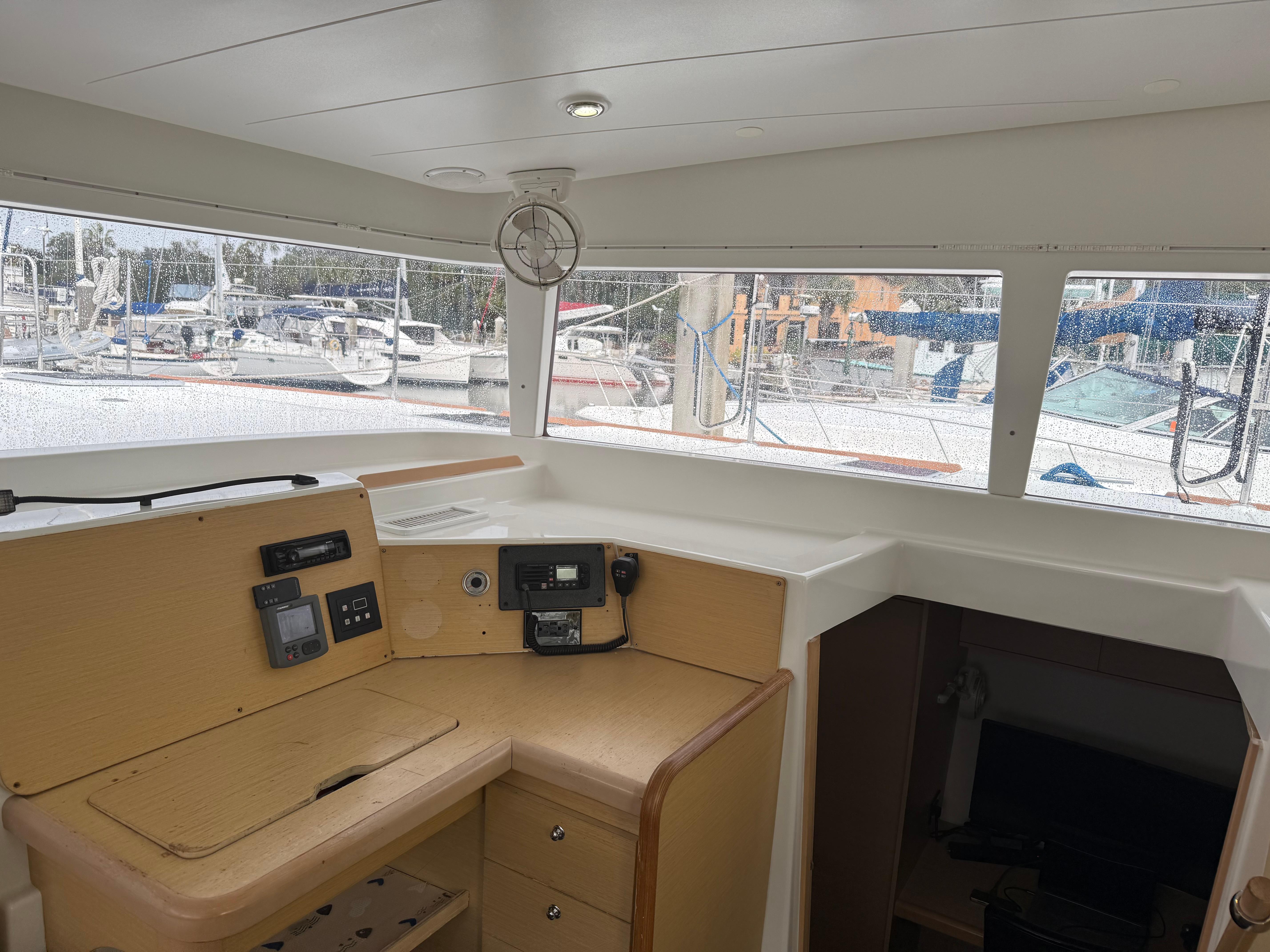 Interior view of 2010 Lagoon 400 catamaran, featuring navigation station and panoramic windows.