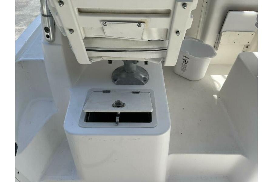 2006 Century 2400 Walk-Around boat interior with storage compartment and seating.