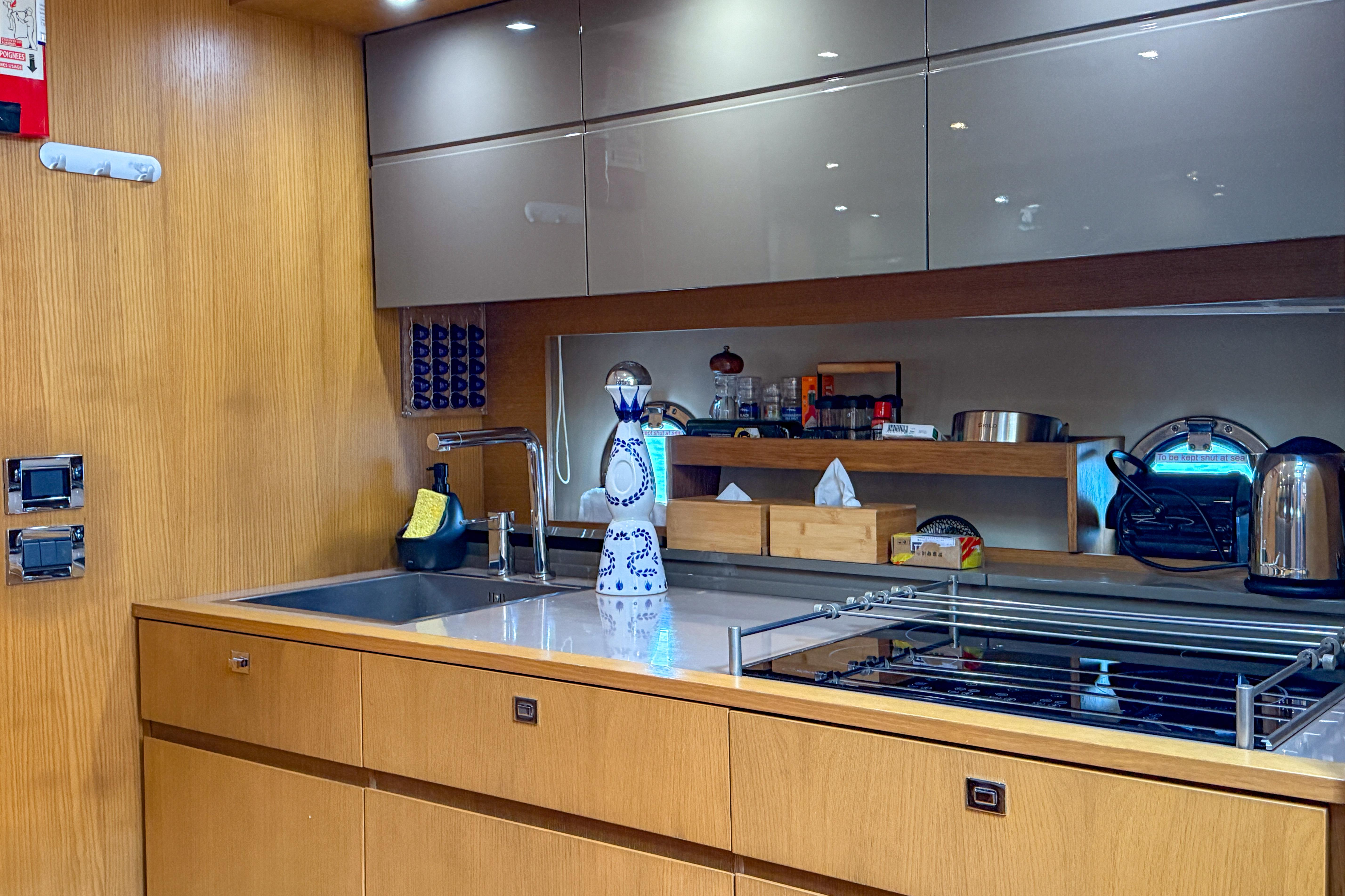 Modern kitchen interior on 2012 Azimut Atlantis 58 yacht, featuring sleek cabinetry and appliances.