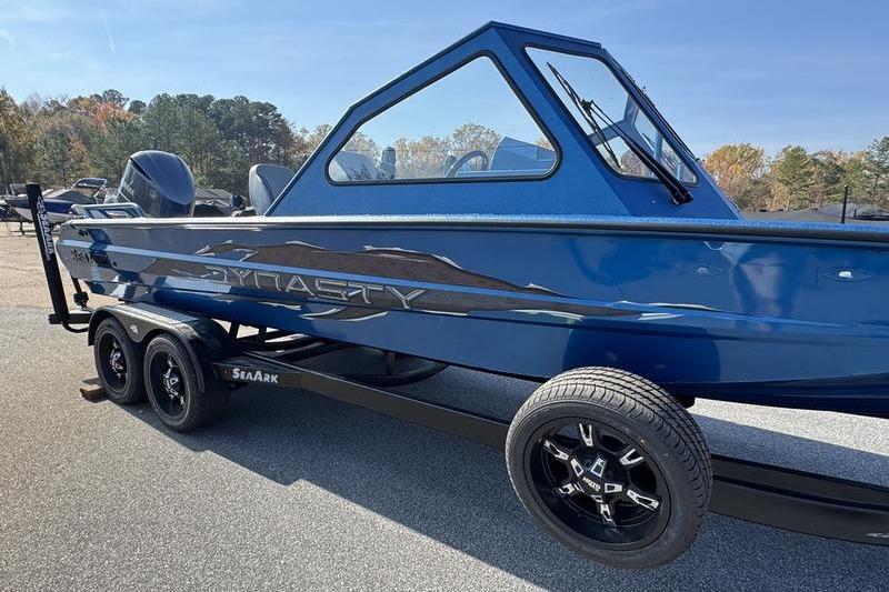 2026 SeaArk Dynasty 2.0 boat in blue, on a trailer, outdoors.