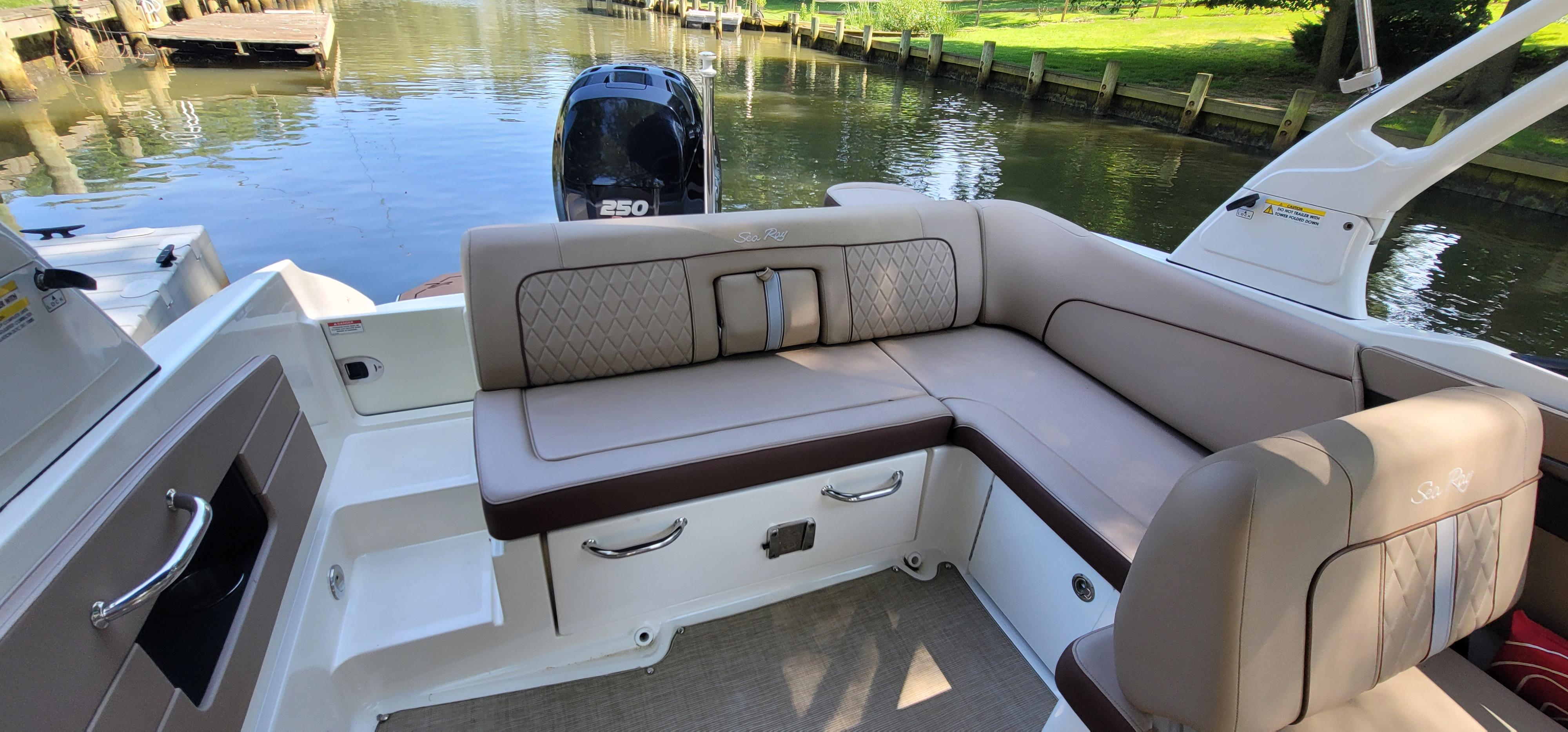 2017 Sea Ray SDX 240 Outboard boat interior with plush seating and scenic water backdrop.
