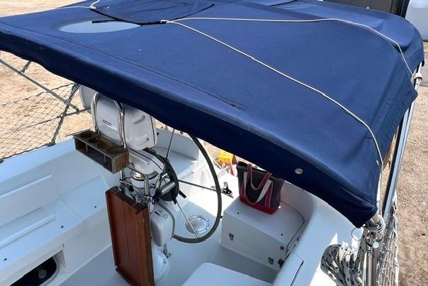 1999 Catalina 34 MkII sailboat cockpit with blue canopy and steering wheel.