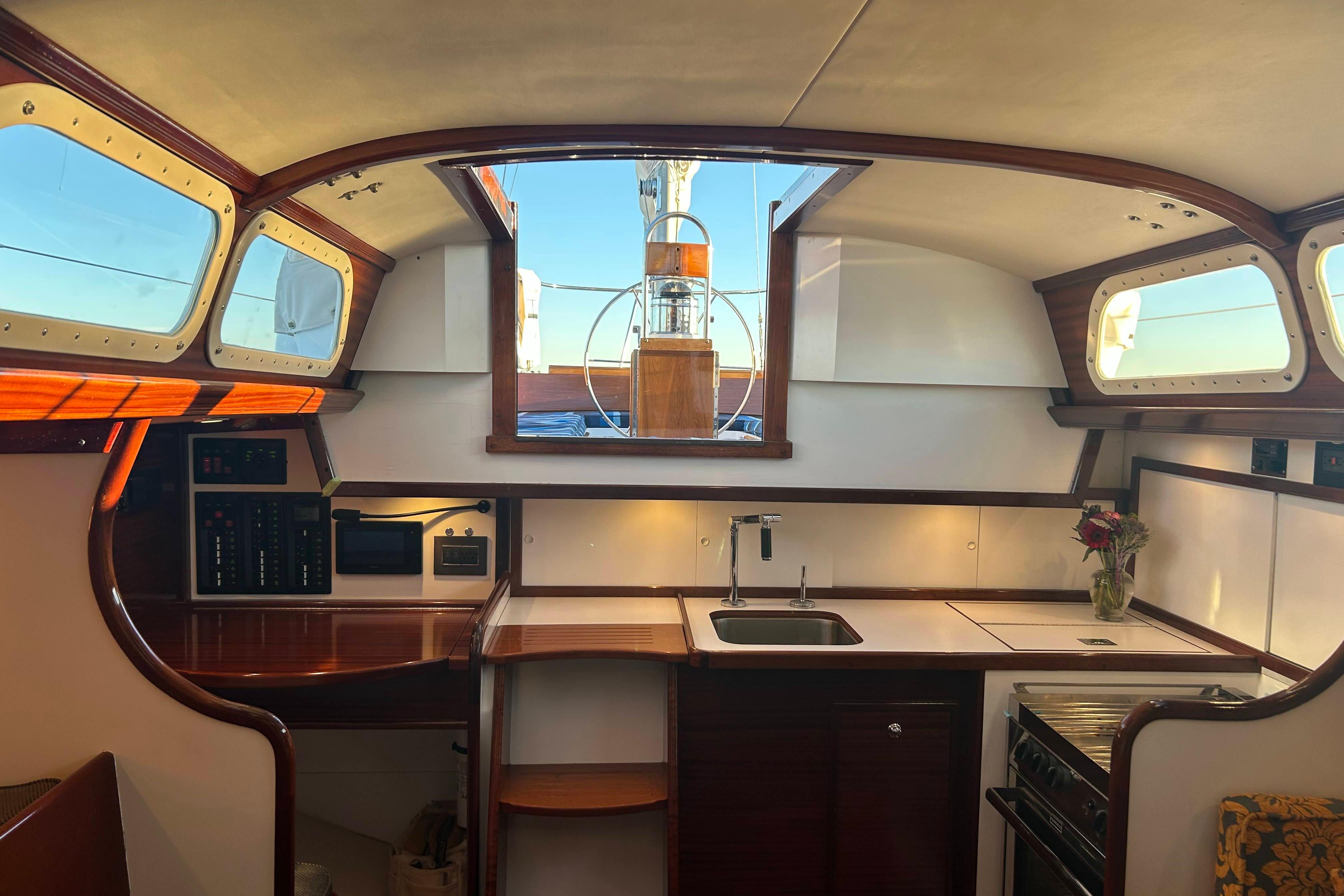 Interior of a 1970 Hinckley Bermuda 40 sailboat with wooden accents and modern amenities.