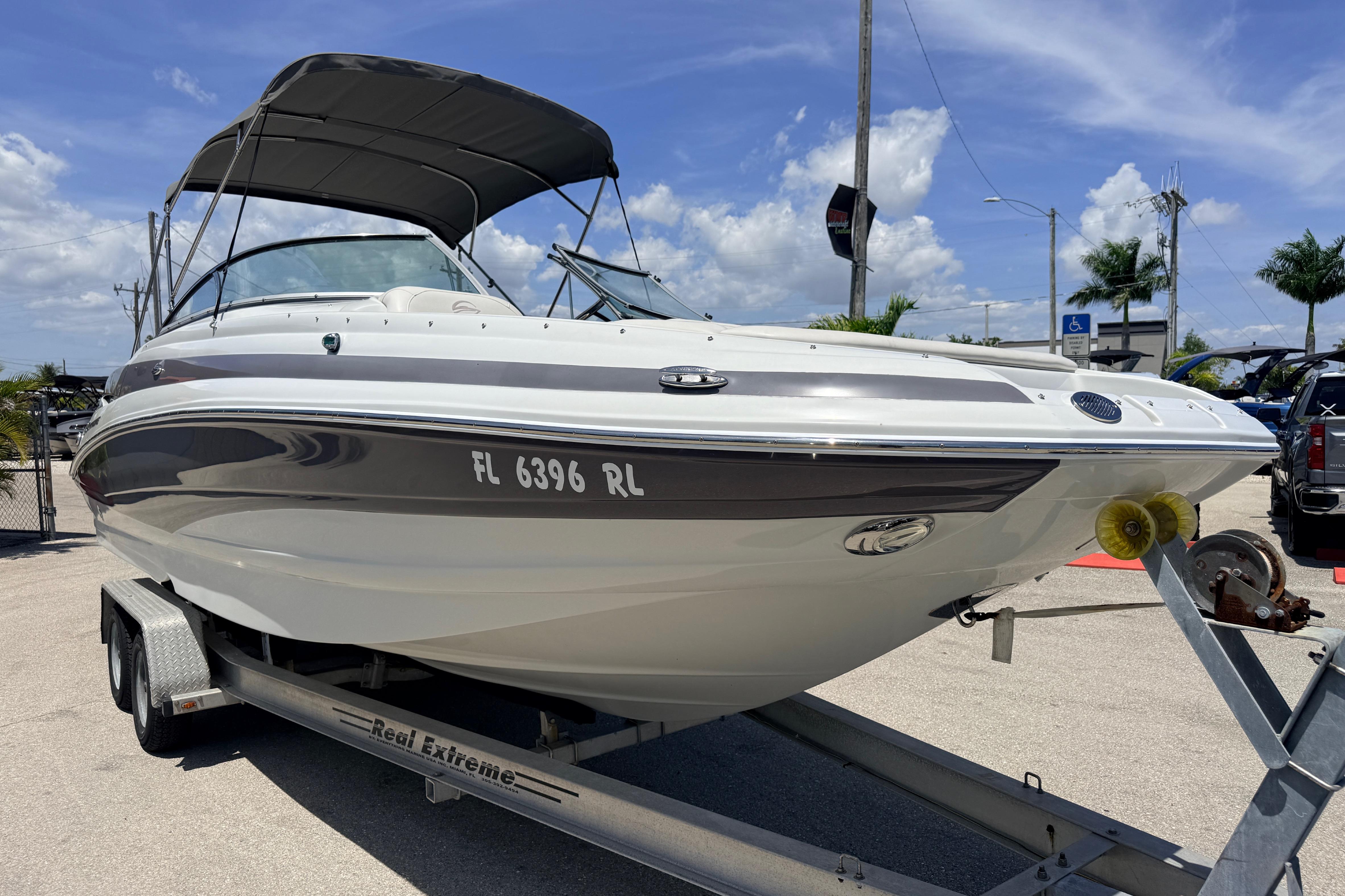 2018 Crownline Eclipse E26 XS boat on trailer under clear blue sky.