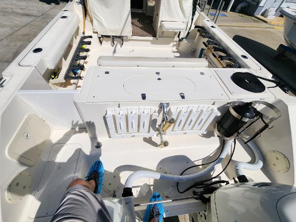 2005 Pursuit 3070 Offshore Center Console boat interior with fishing gear and equipment.