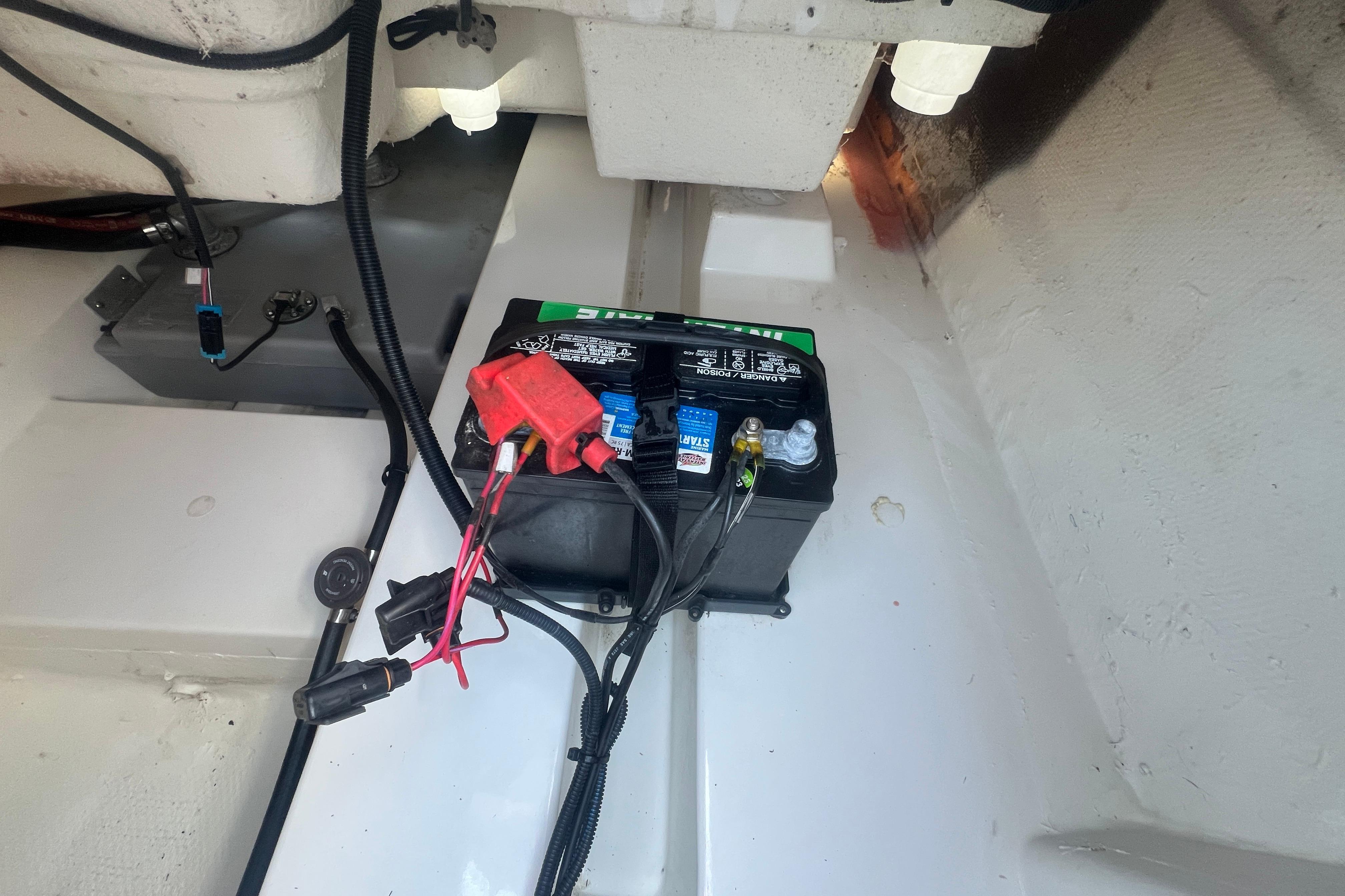 Battery setup in a 2023 Tahoe T16 boat, featuring cables and connectors.